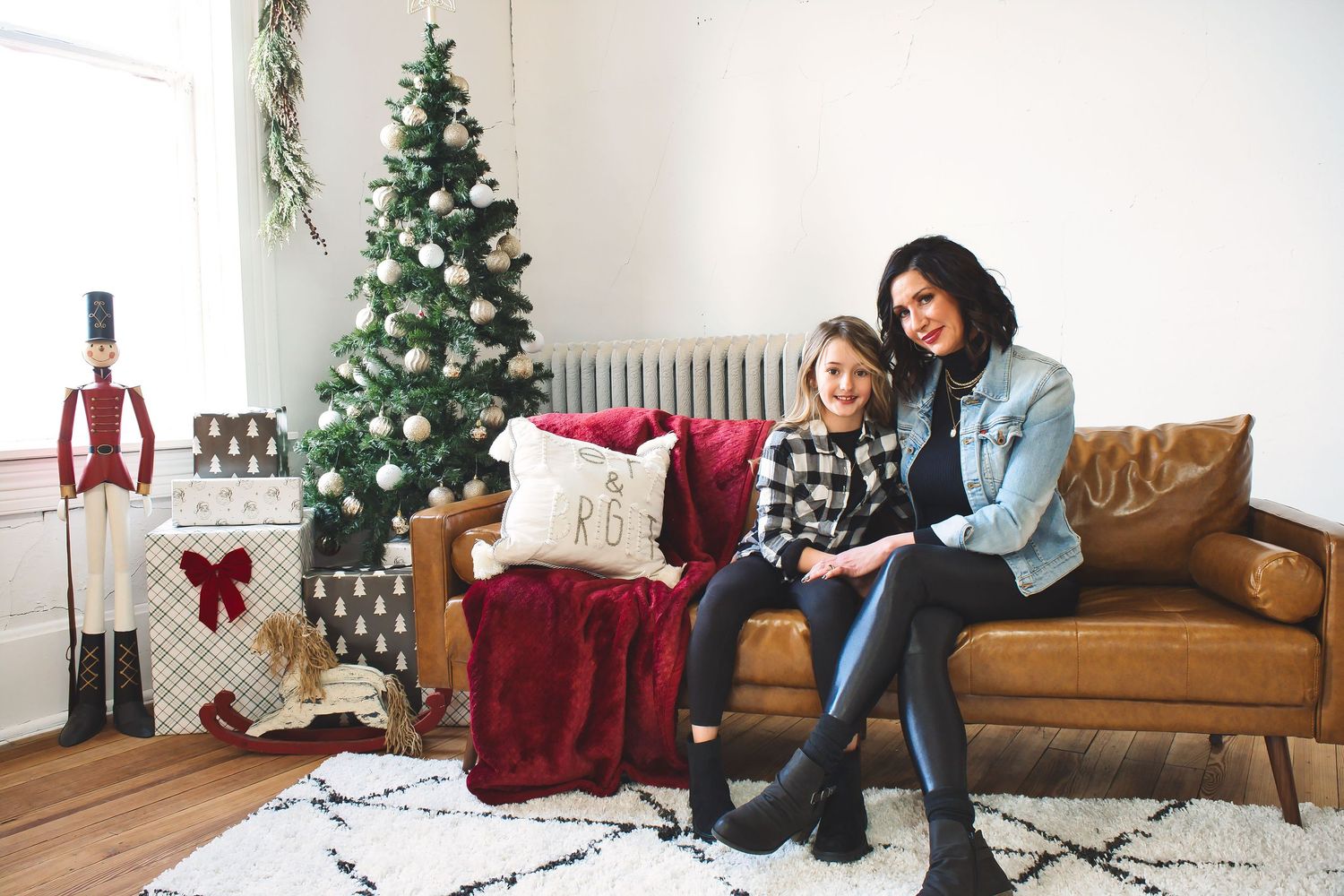 Holiday themed indoor photoshoot with Christmas decorations and cozy furniture.