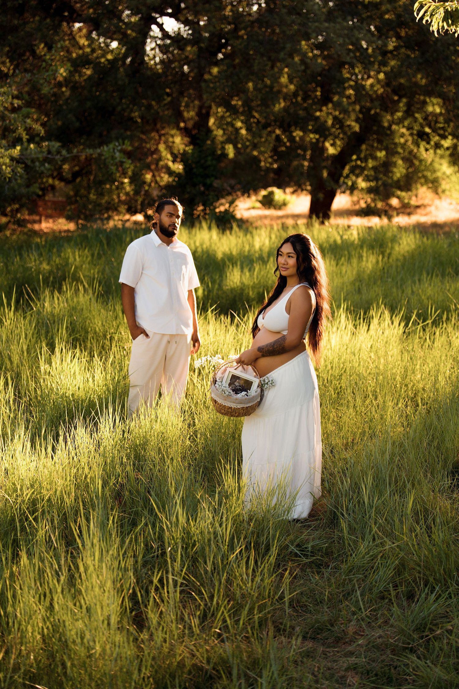 Expecting couple during an outdoor maternity session at golden hour