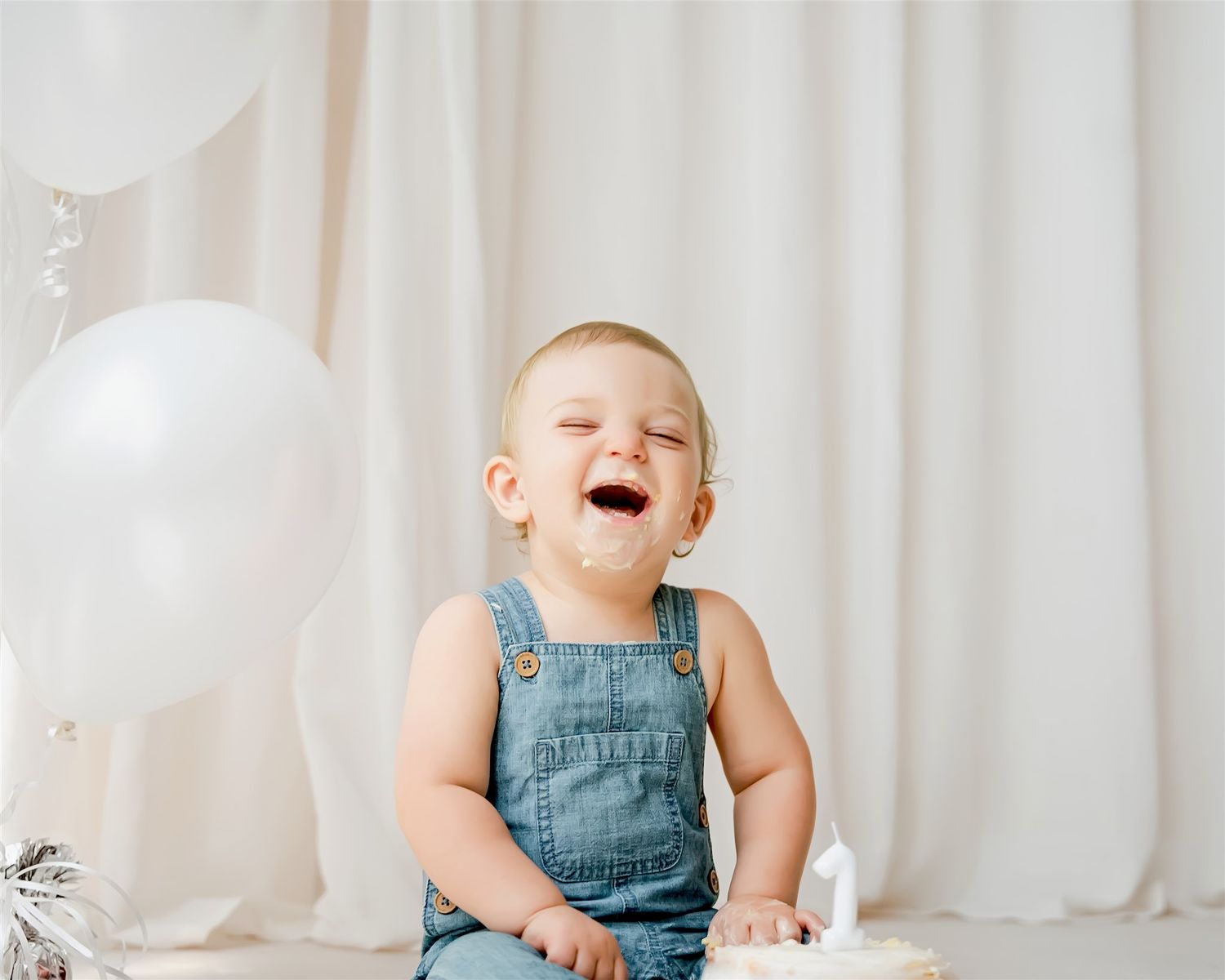 Baby sitting during a cake smash session in a neutral studio setting in Waterloo Region