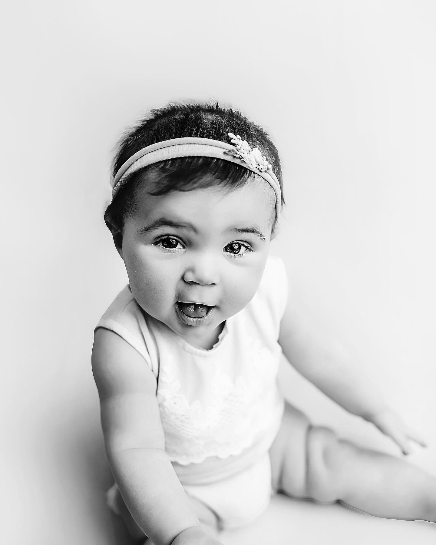 Black and white baby portrait photographed in studio with simple, natural styling