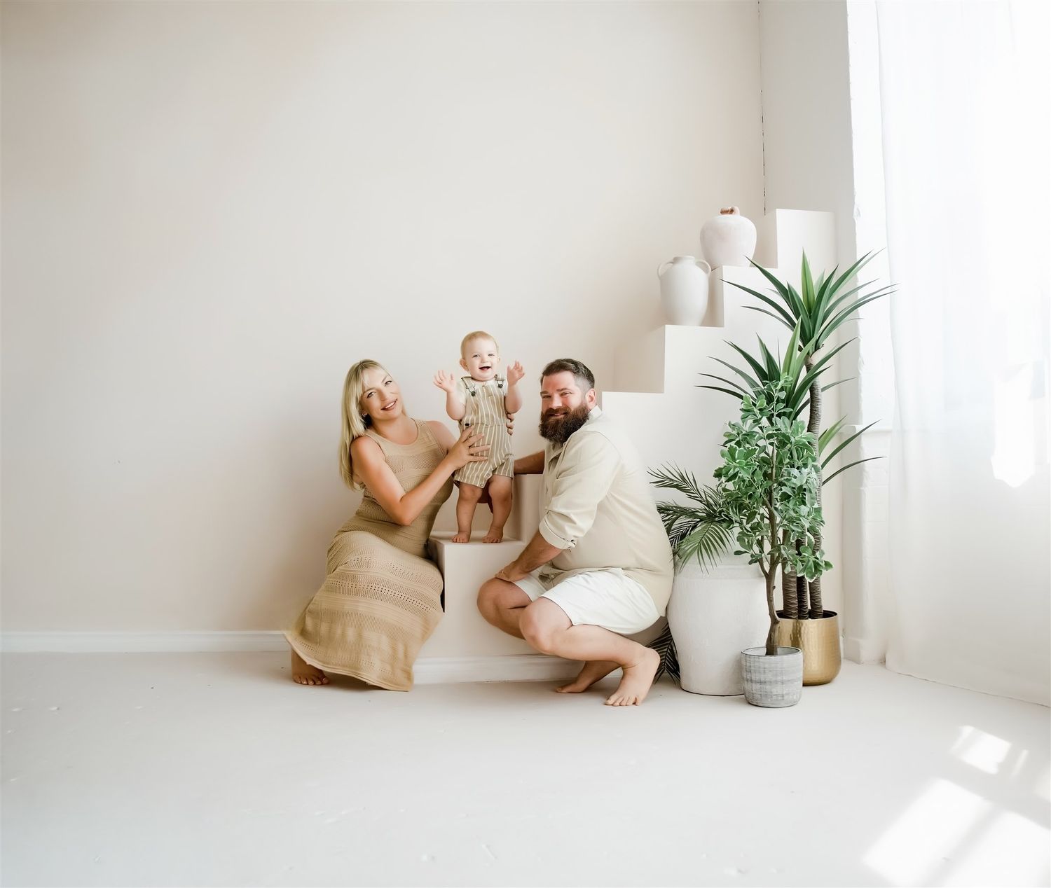 Bright airy lifestyle photo of a woman in a white outfit in a modern minimal interior