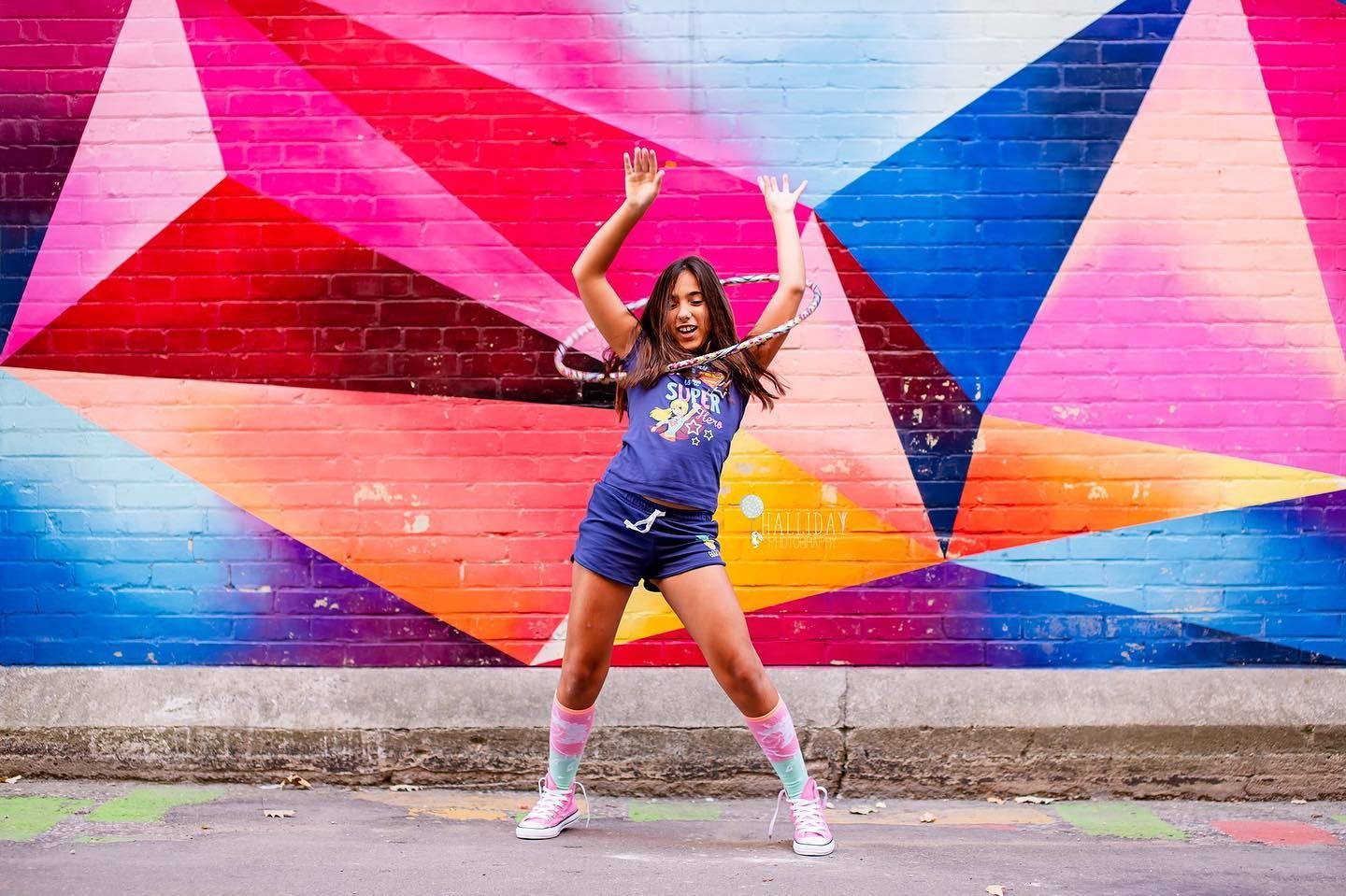 birthday portrait of a young girl infront of colourful grafiti