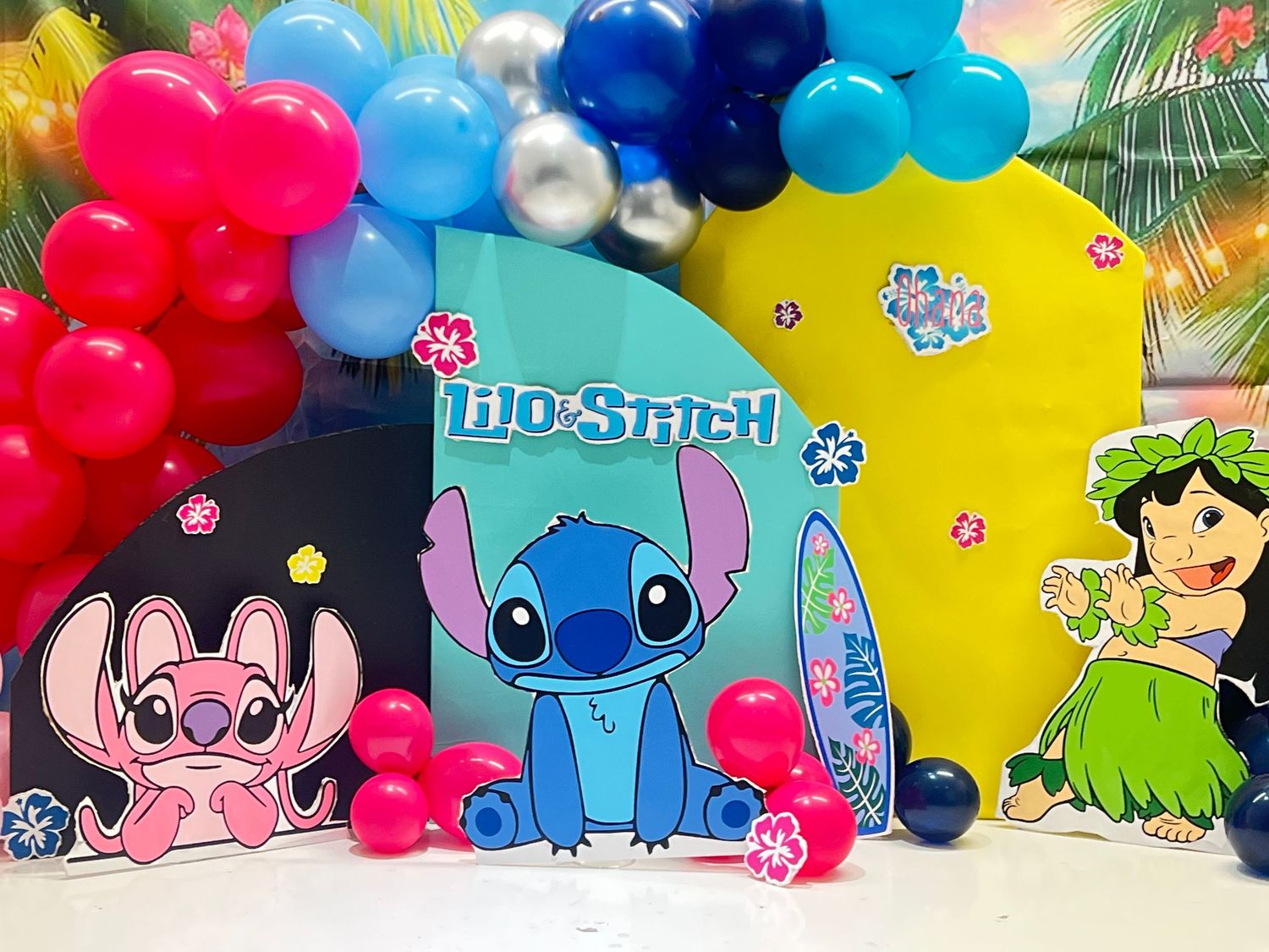 Themed cake smash setup with colorful balloons and party decor photographed in studio
