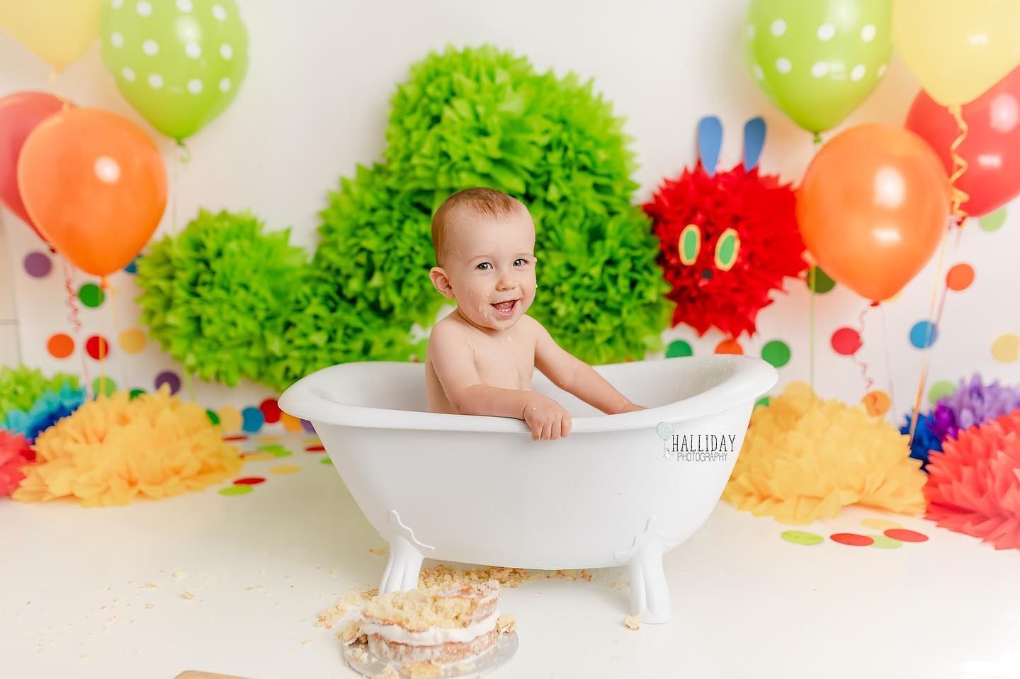 First birthday cake smash portrait with colourful balloons and themed decor