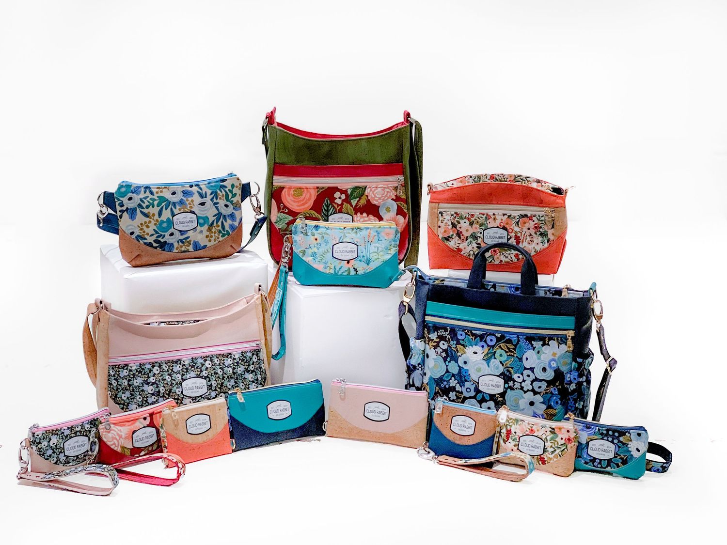 Flatlay of colorful patterned bags and pouches arranged on a white surface