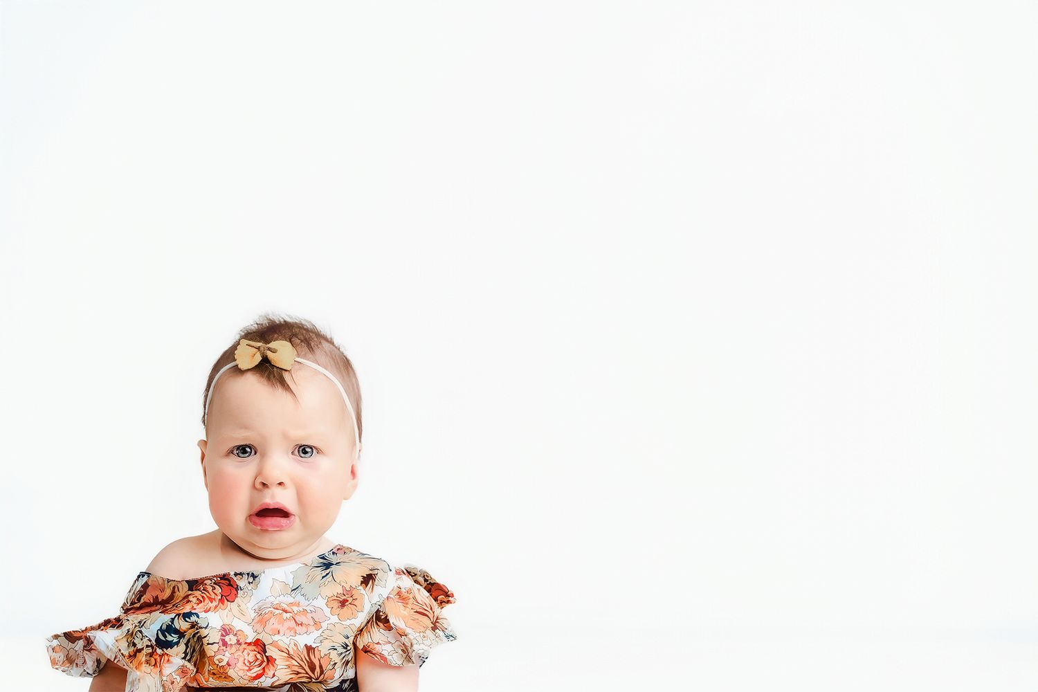 Clean studio baby portrait photographed against a white backdrop
