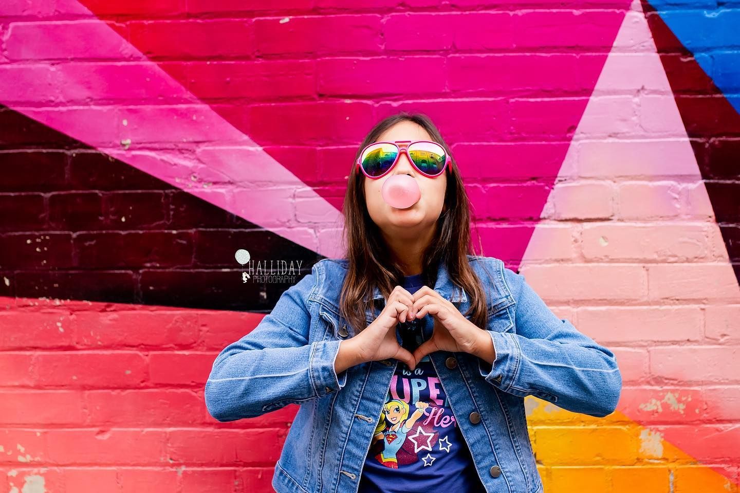 young girl blowing bubbles with bubblegum
