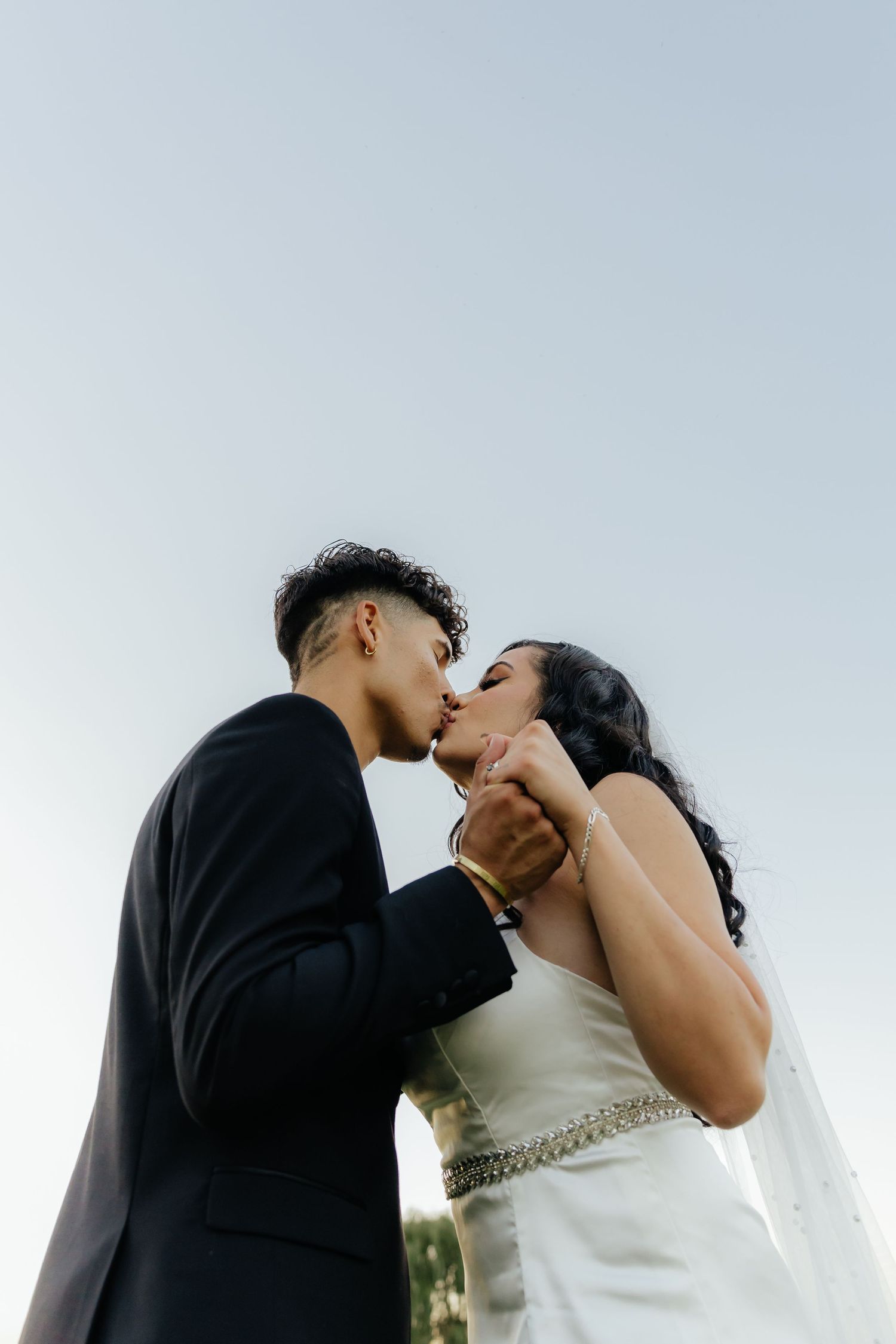 Bride and groom sharing an intimate moment during golden hour wedding portraits