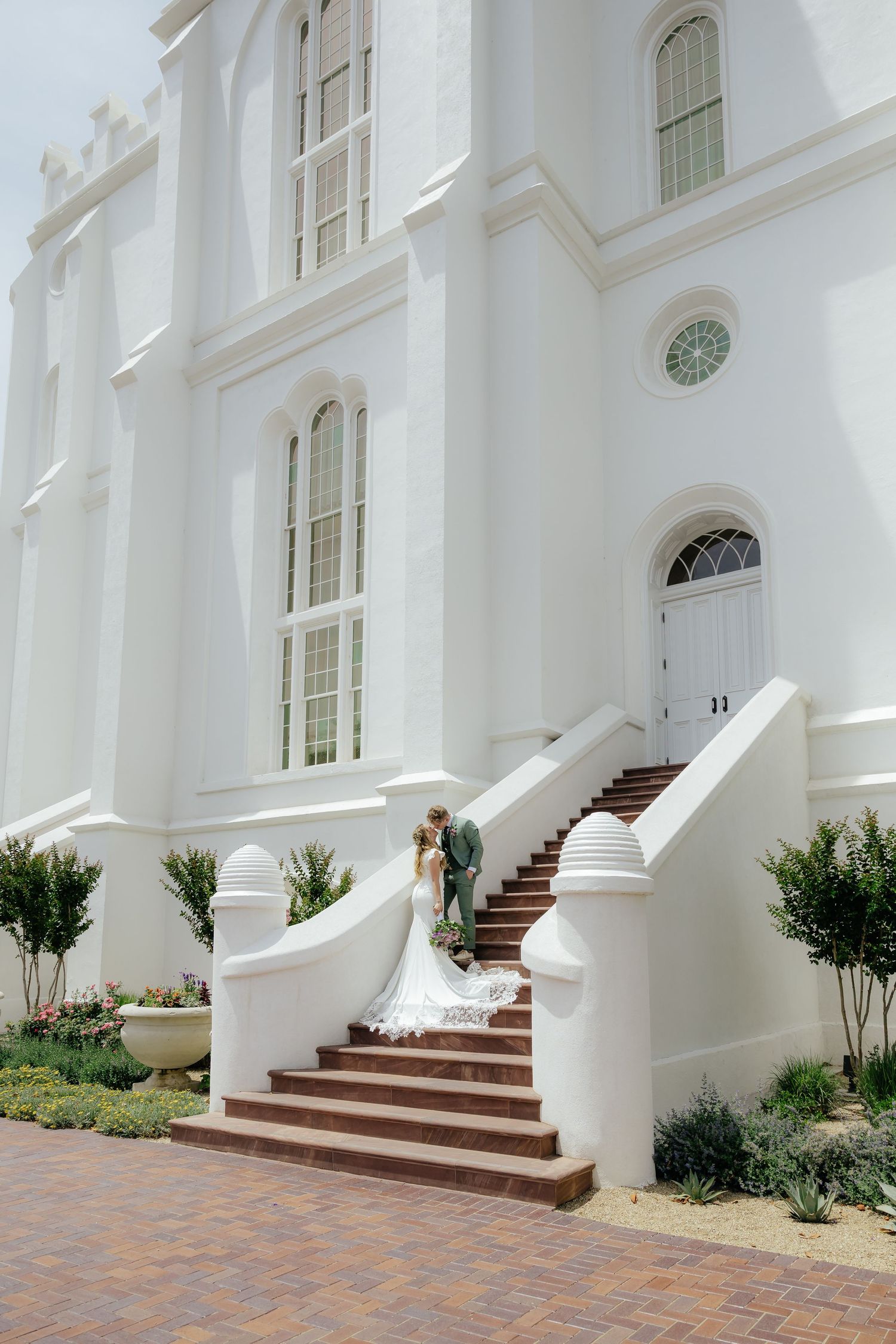 Couple kissing standing on beautiful steps of the St. George Utah LDS temple