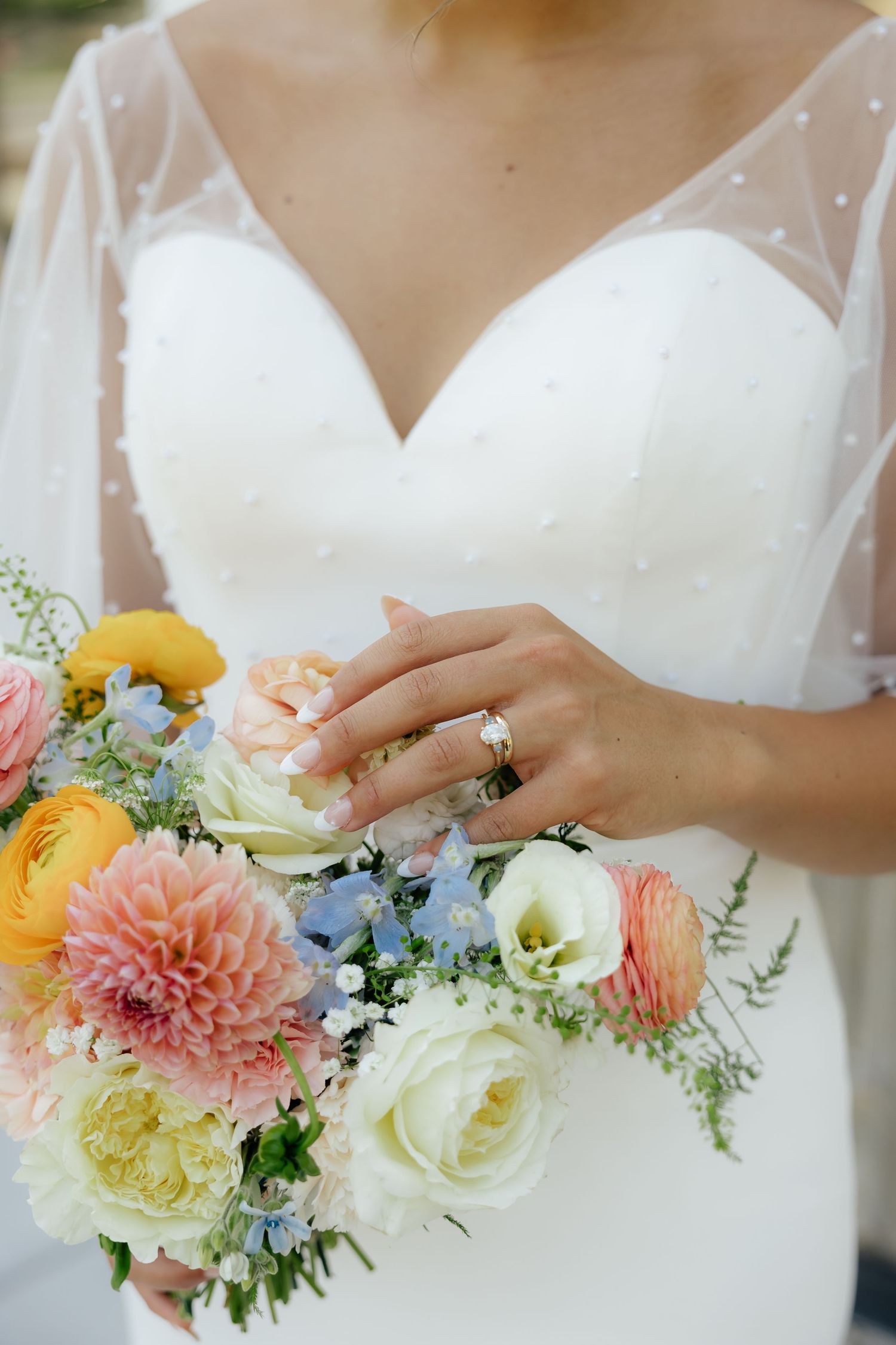 Bride holding a vibrant bouquet during an editorial wedding portrait