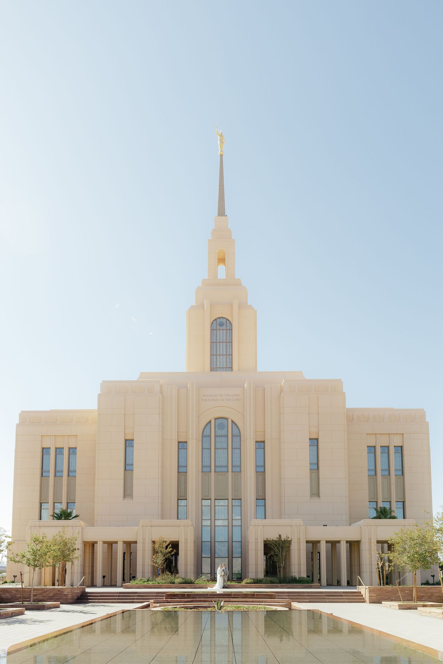 LDS temple wedding couple standing together in front of St. George Utah temple