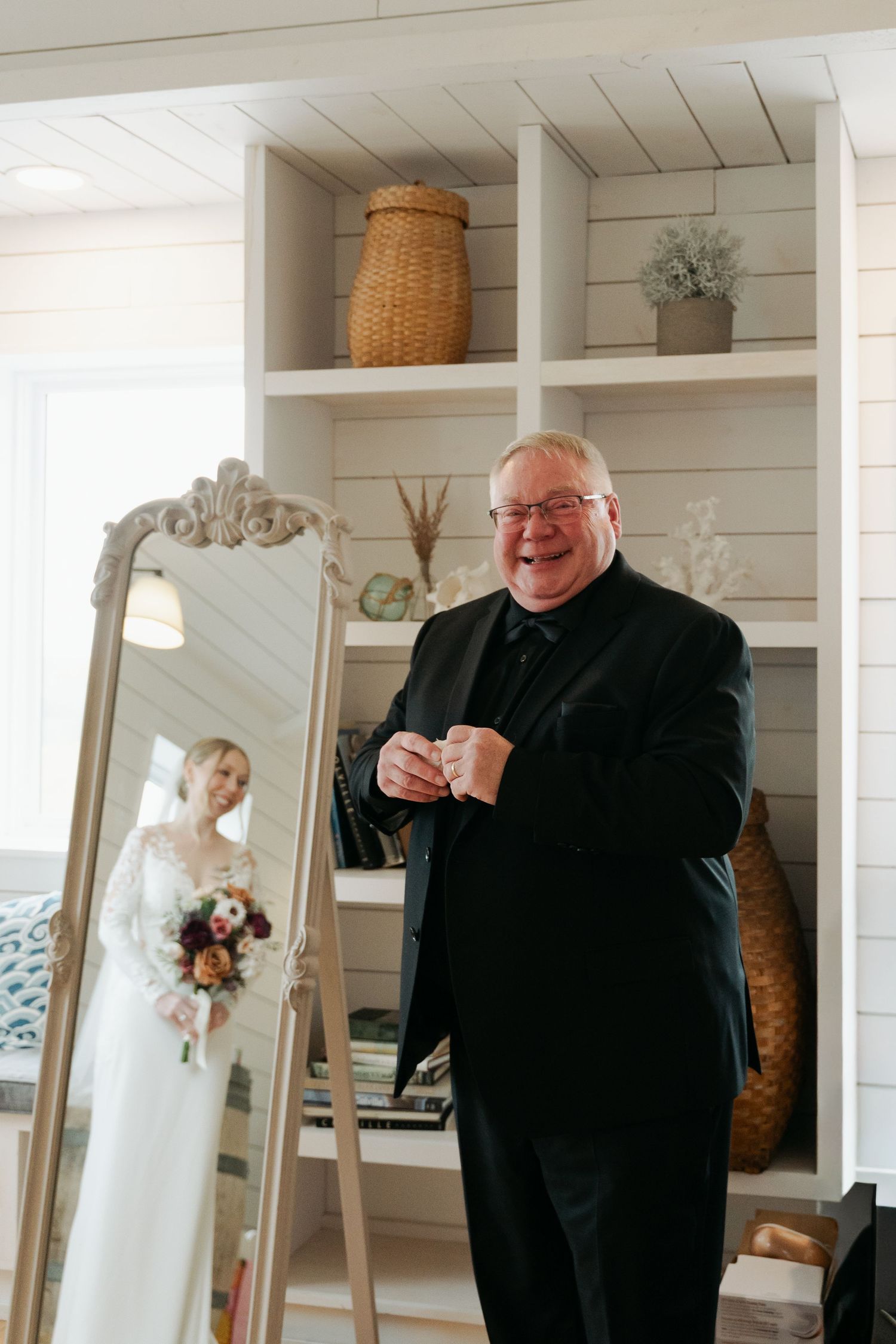 An emotional reaction captured during a wedding first look in a bright white room with shiplap walls at Lightfoot & Wolfville.