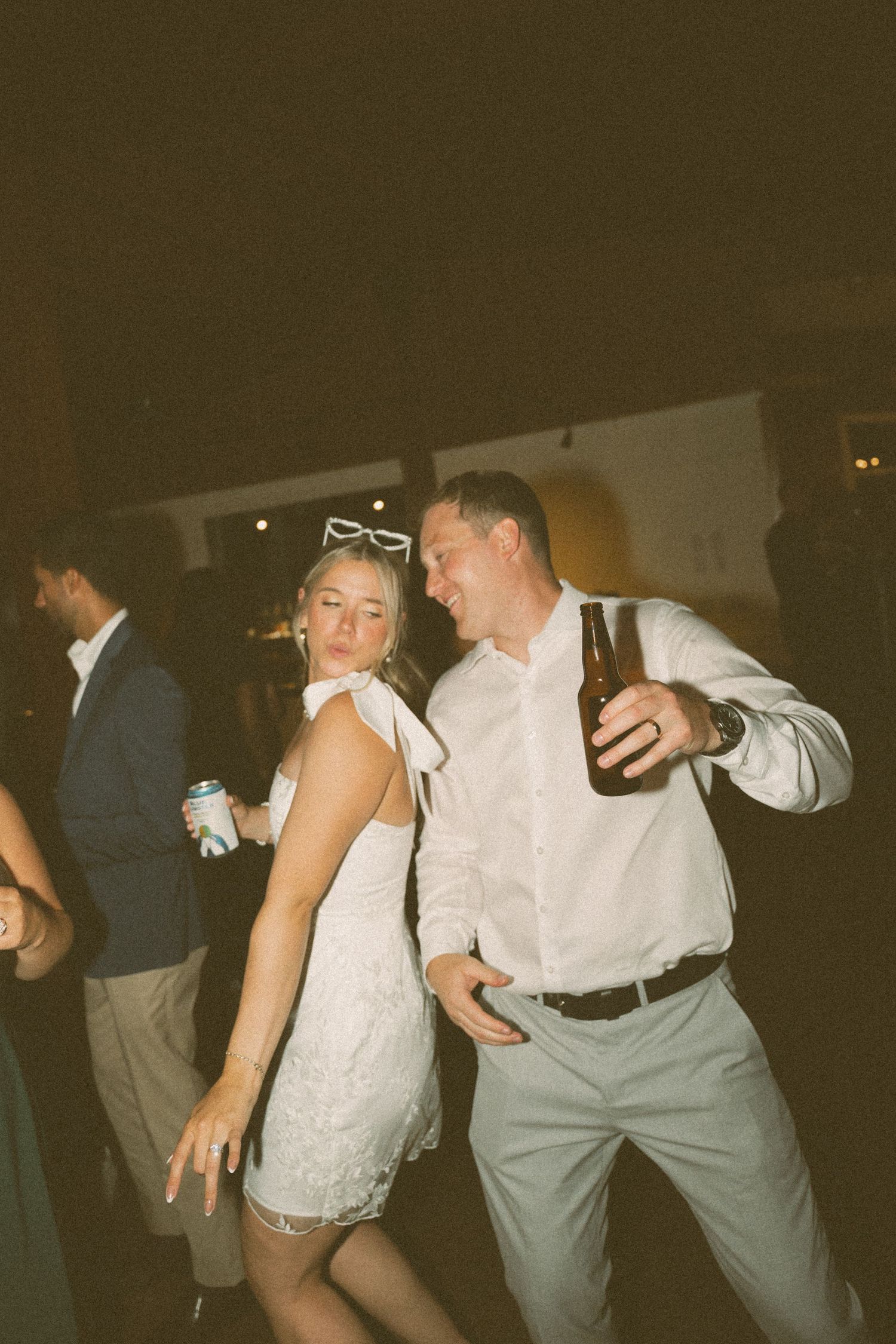 Wedding reception guests dancing in vintage-style lighting and formal attire in Halifax, Nova Scotia.