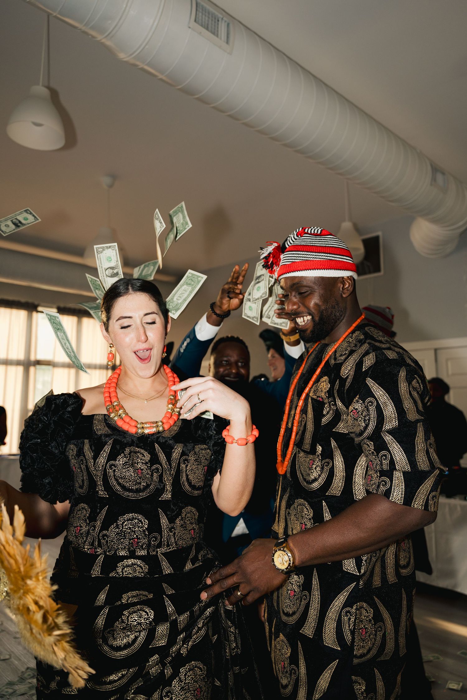 A lively party scene with people in black and gold patterned outfits throwing money in the air in Halifax, Nova Scotia.