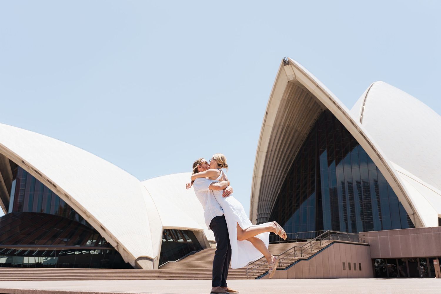 A series of five photos showing different angles of the iconic Sydney Opera House's white architectural sails against a blue sky.