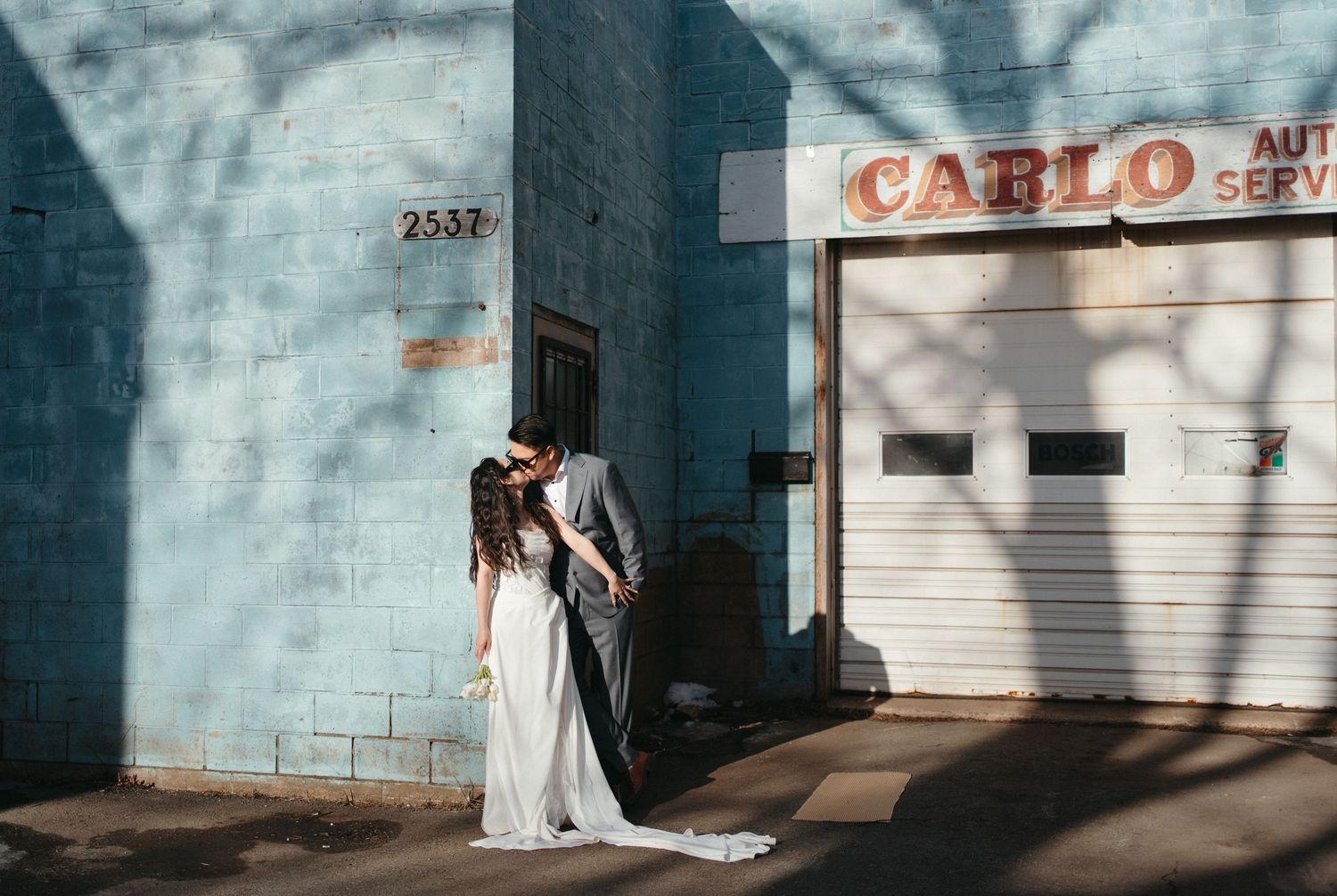 A series of wedding photos showing couples and details against blue walls and urban backdrops in Halifax, Nova Scotia.