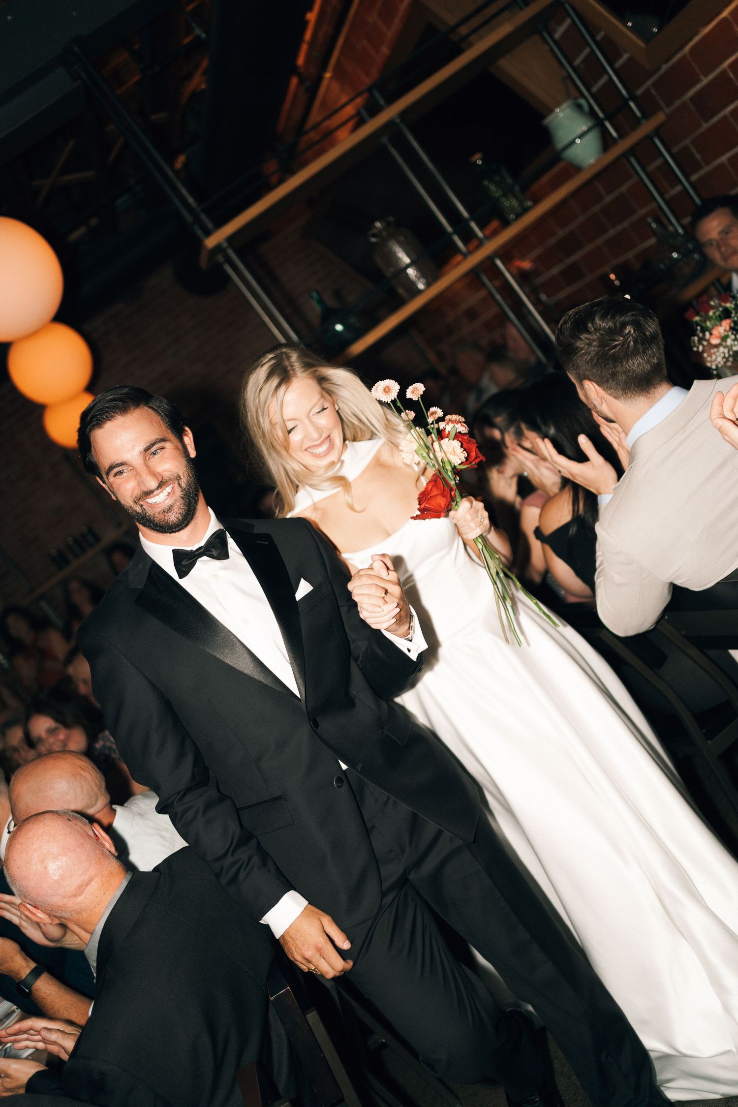 Wedding guests in formal attire dancing and celebrating at an evening reception in Halifax, Nova Scotia.