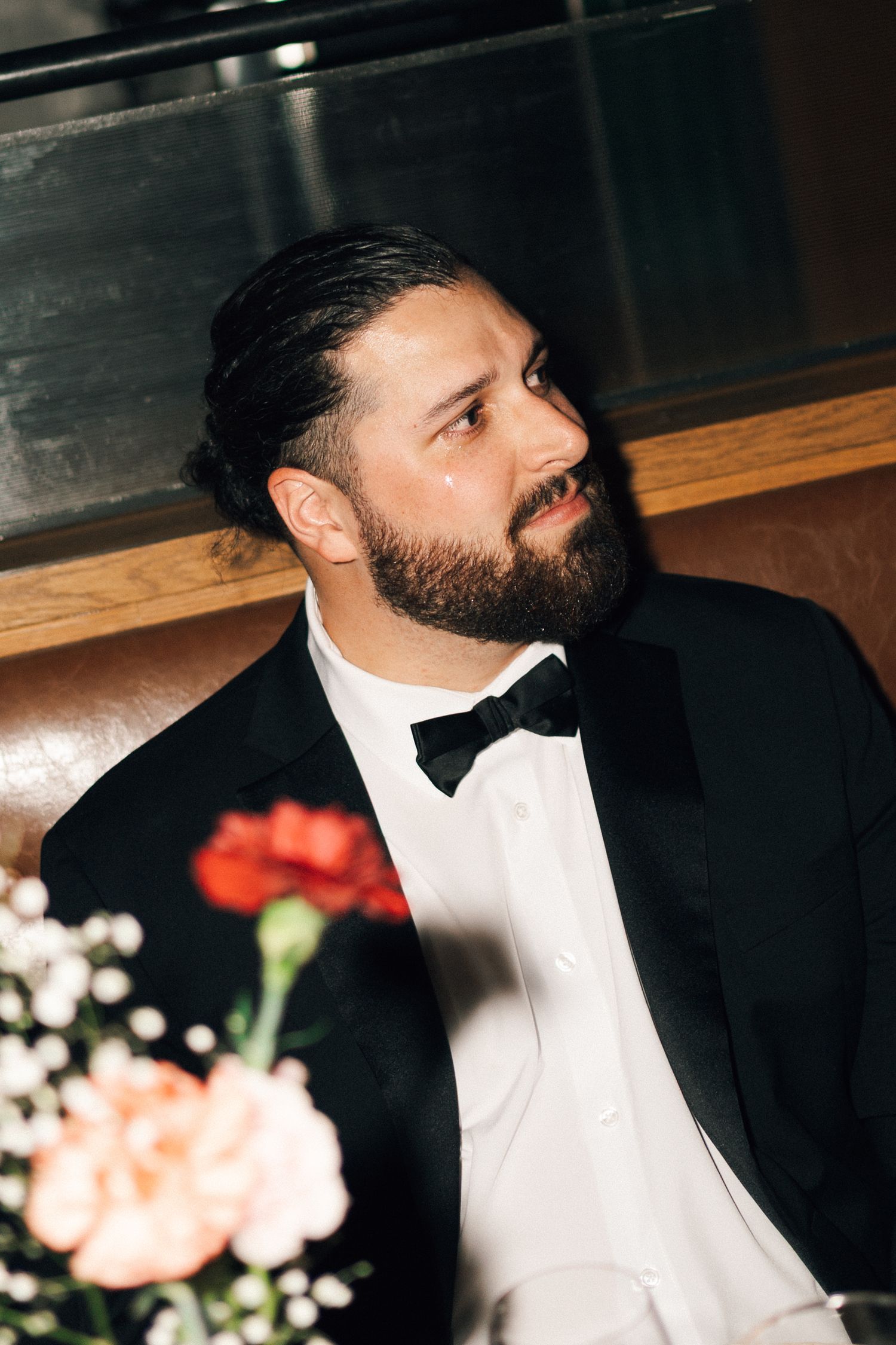 A person in a black tuxedo and white shirt sits at a formal event in Halifax, Nova Scotia.