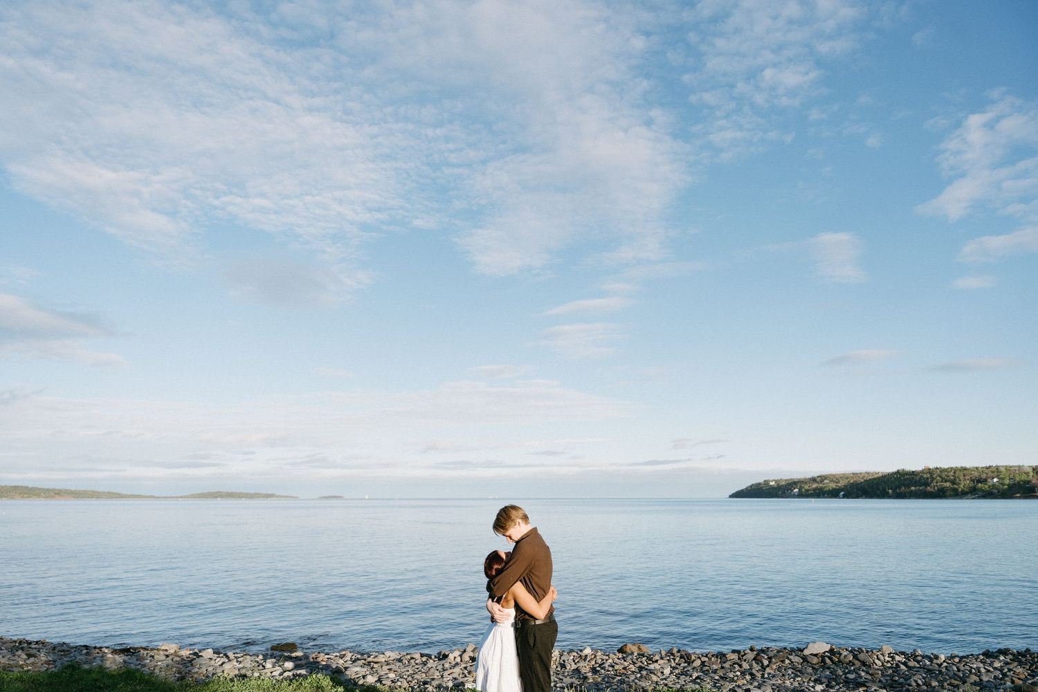 A scenic panoramic series of beach landscapes with rocky shores and blue skies along a peaceful coastline in Halifax, Nova Scotia.