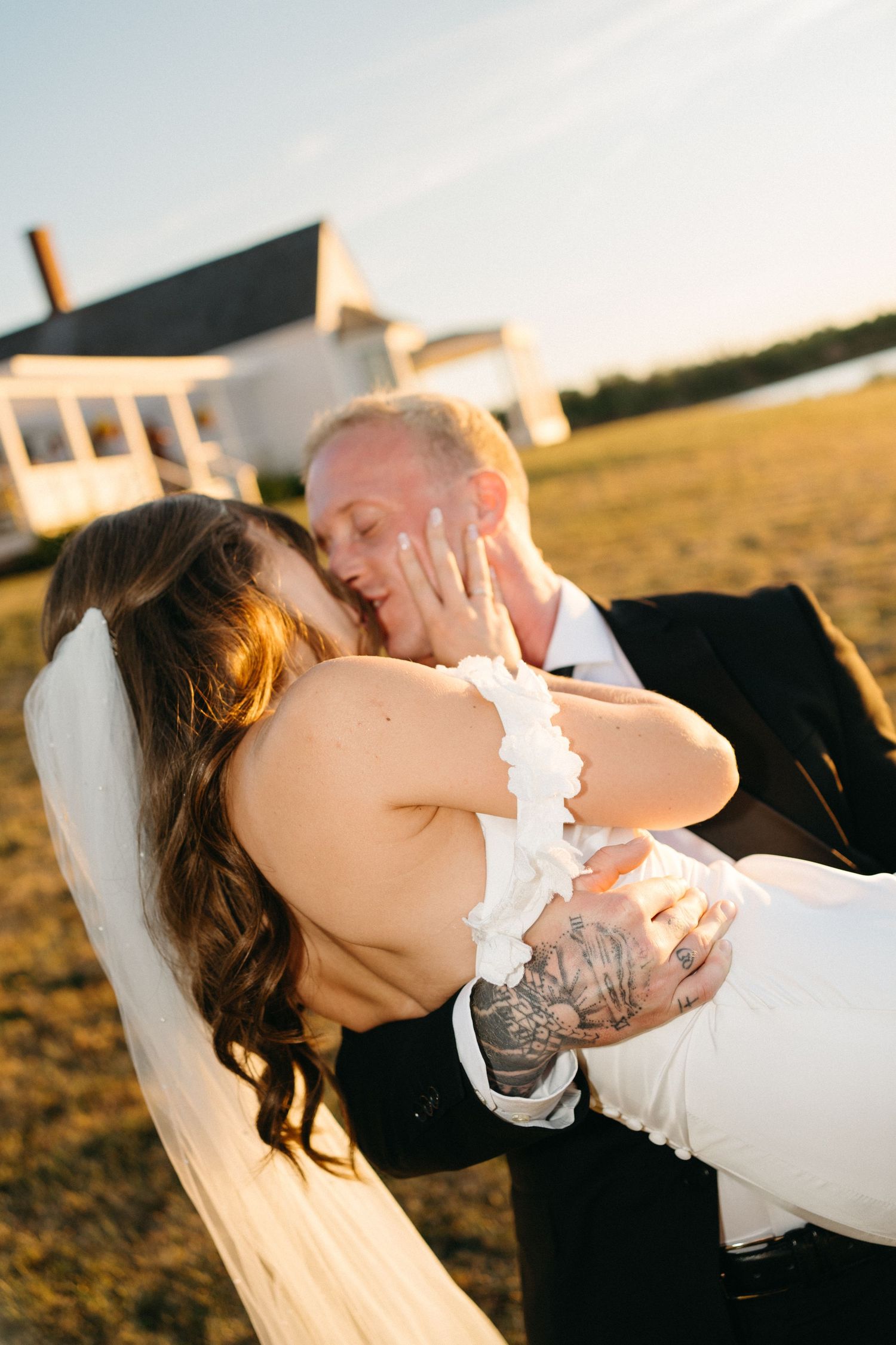 Romantic sunset portraits of newlyweds sharing an intimate moment in warm evening light in Halifax, Nova Scotia.