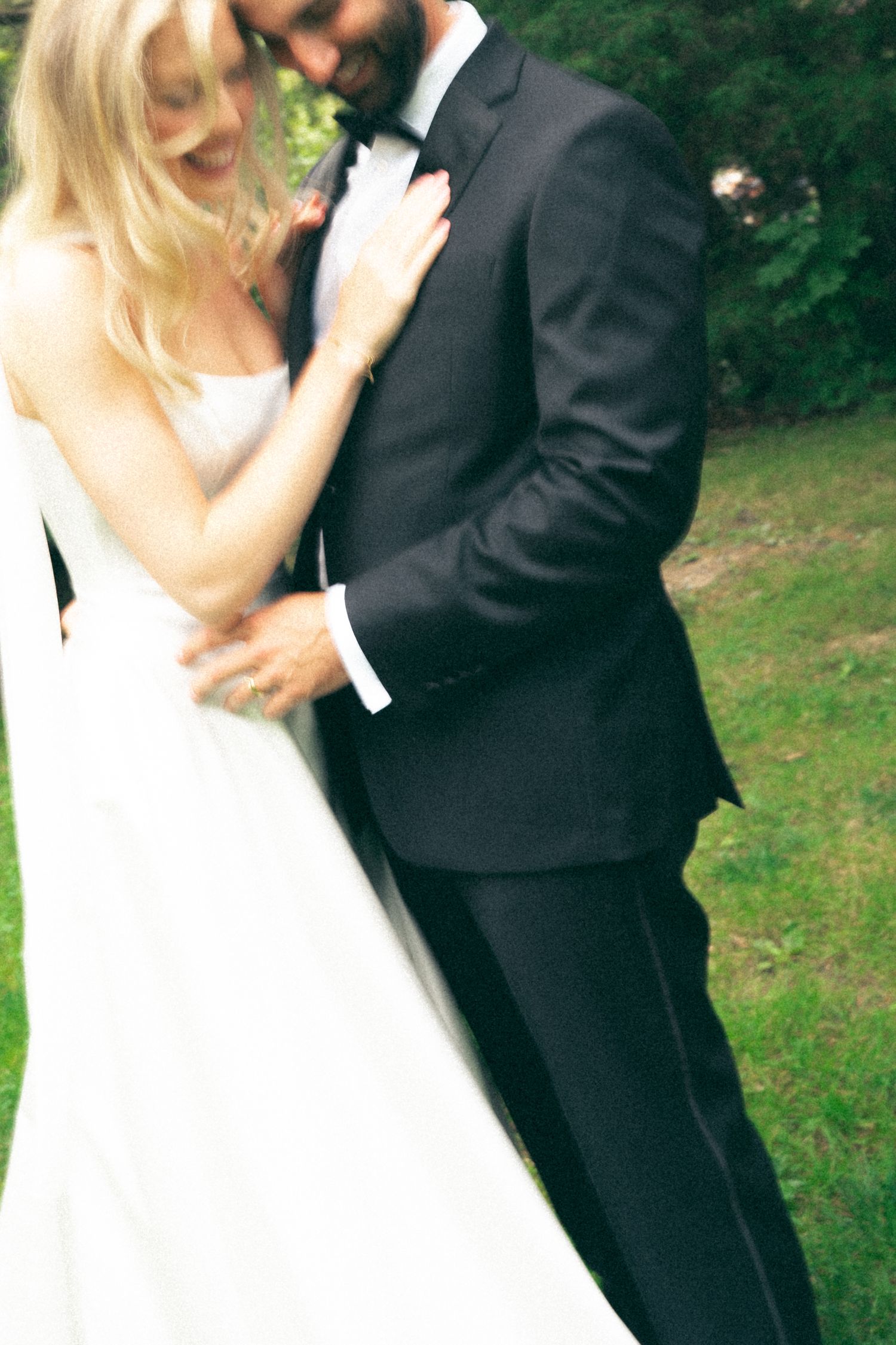 Romantic wedding portraits showing tender moments between newlyweds in a garden setting in Halifax, Nova Scotia.