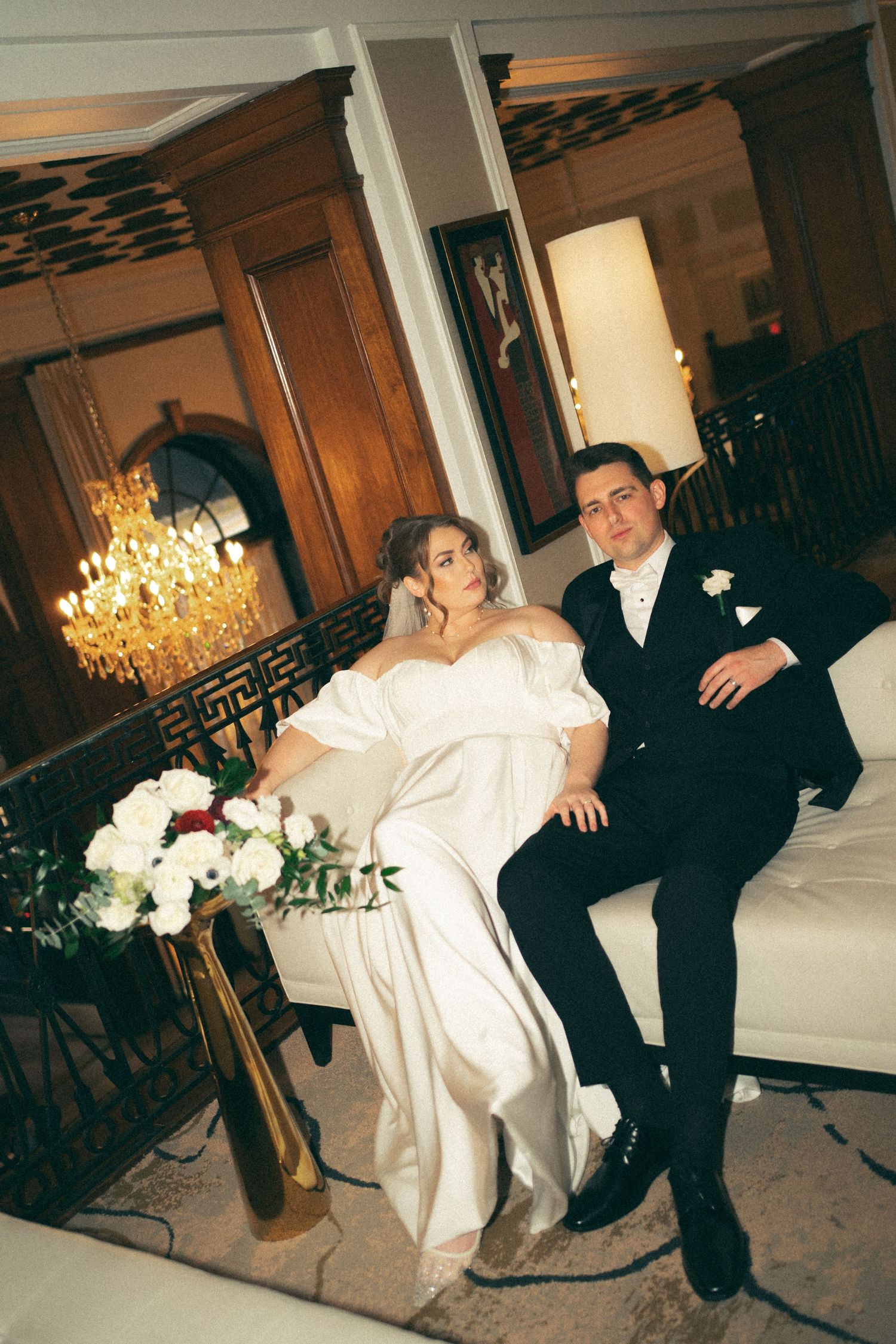 A couple dances together in an ornate room with a crystal chandelier in Halifax, Nova Scotia.