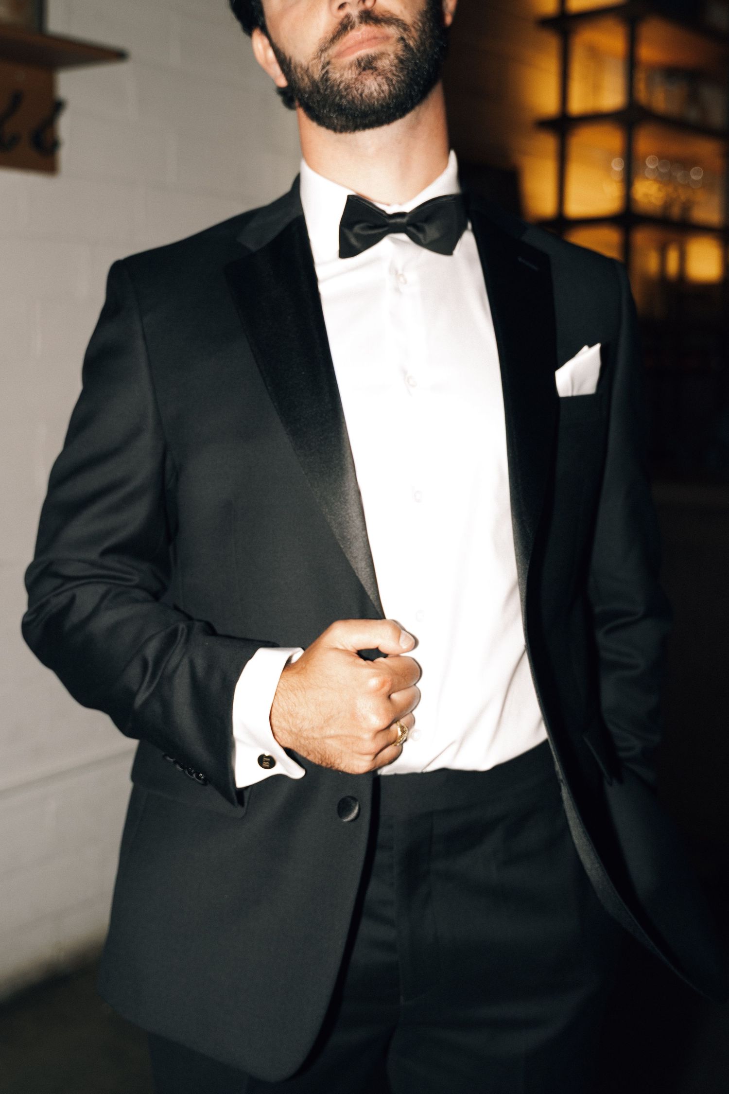 Close-up details of a groom's classic black tuxedo and bow tie in Halifax, Nova Scotia.