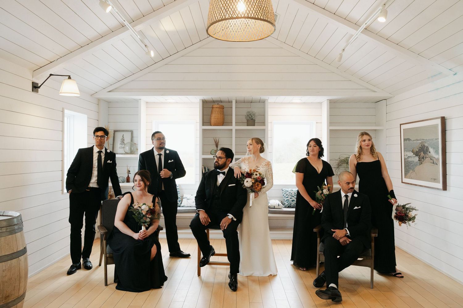 Panoramic view of a minimalist white chapel interior with guests seated on both sides at Lightfoot & Wolfville.