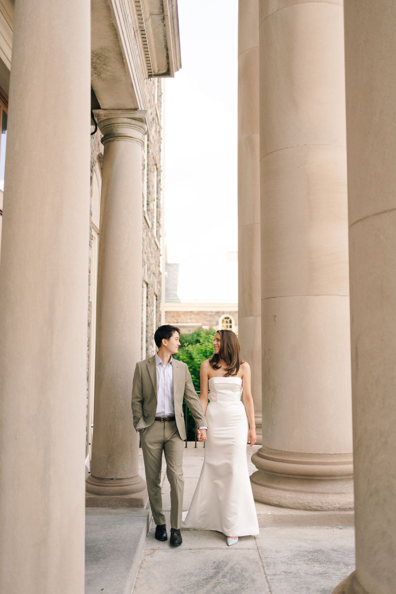 A romantic wedding photo sequence showing a couple among elegant white stone columns at a classical venue in Halifax, Nova Scotia.
