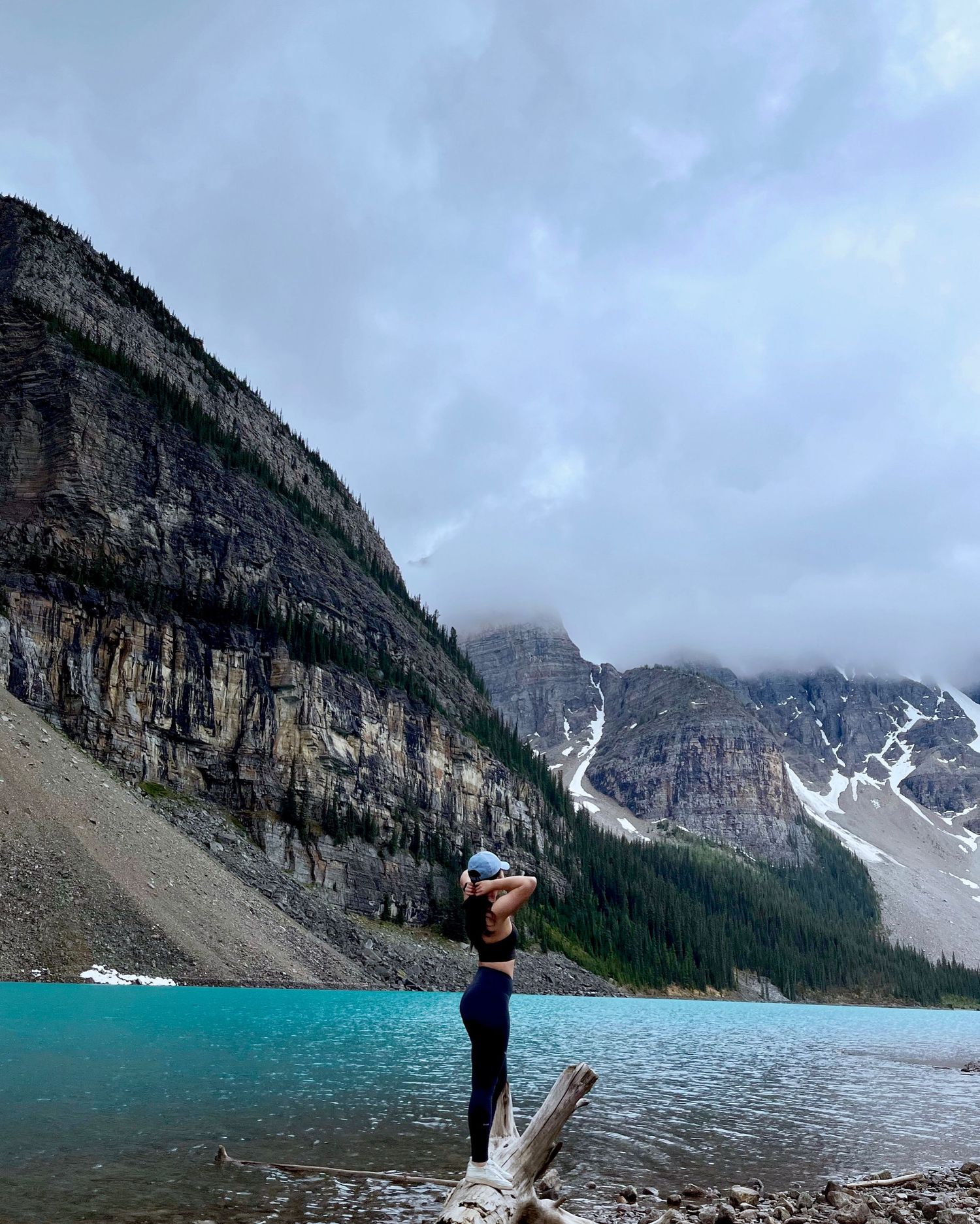 Panoramic view of Lake Louise in Banff National Park with turquoise waters and towering mountain cliffs in the background.