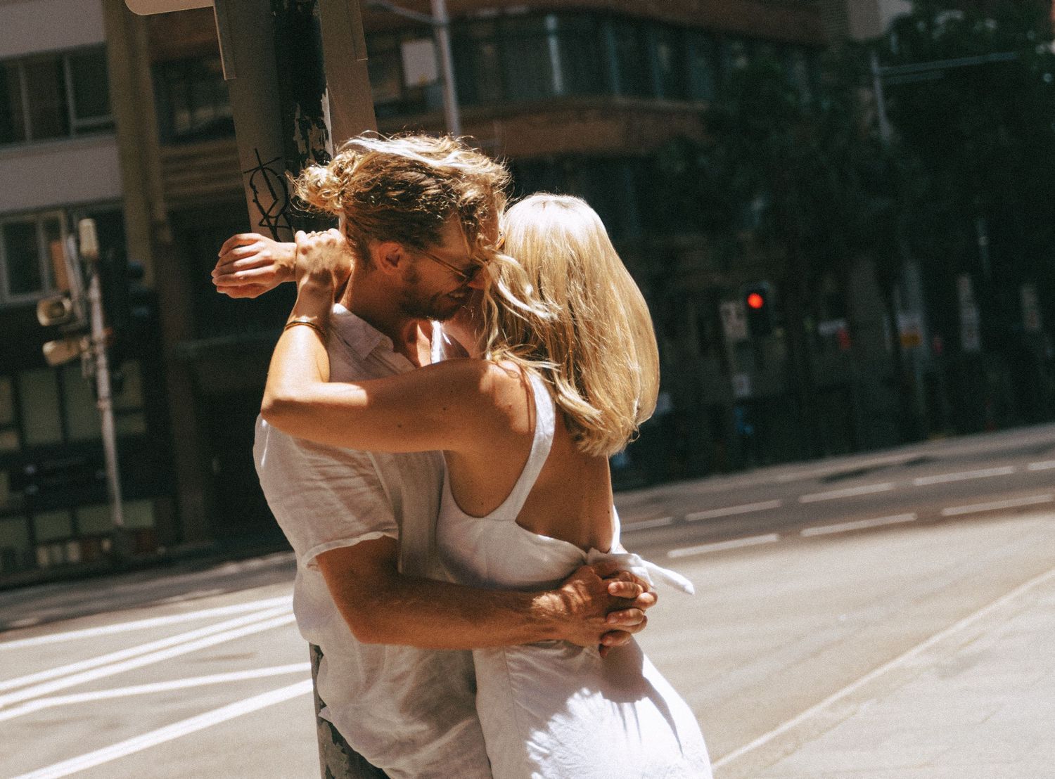 A couple embraces in a romantic dance move on a city street in Halifax, Nova Scotia.