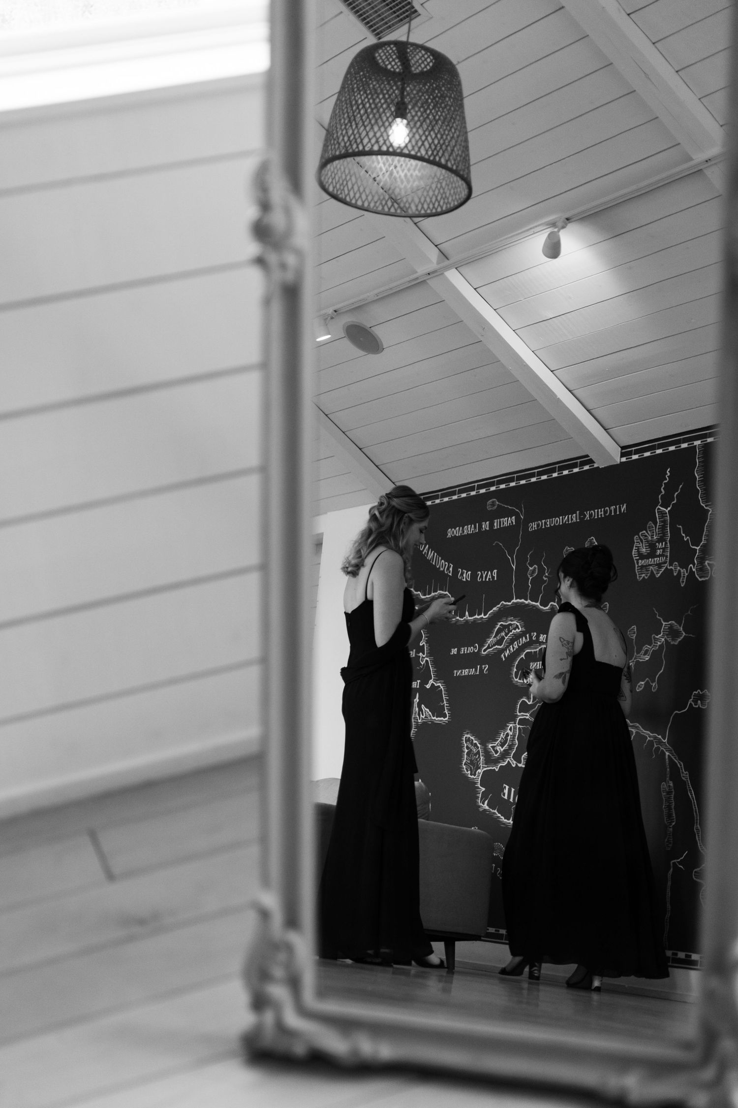 Black and white image showing silhouettes against a chalkboard wall with drawings at Lightfoot & Wolfville.