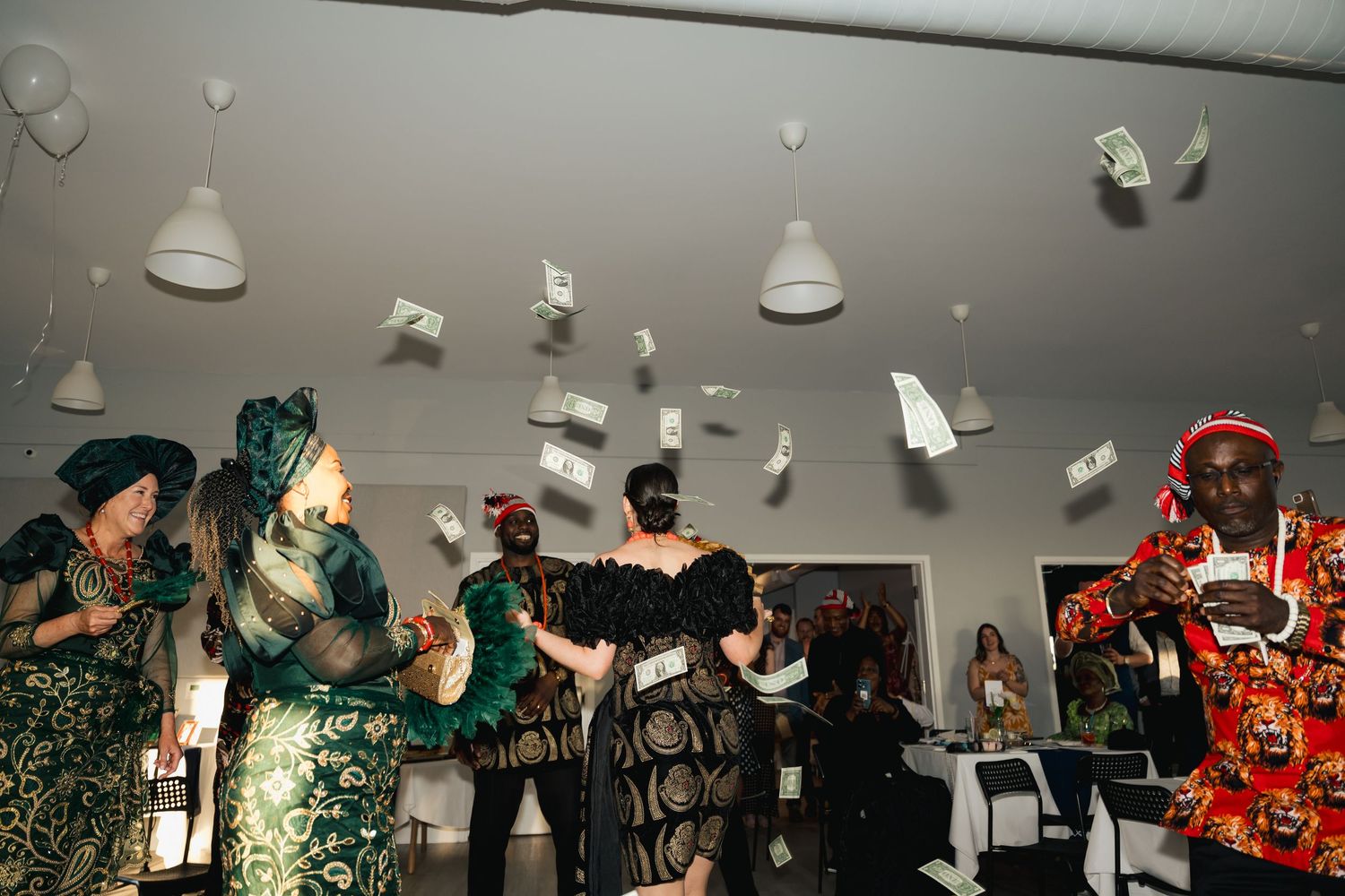 White pendant lights hang from the ceiling at a wedding reception venue creating ambient lighting in Halifax, Nova Scotia.