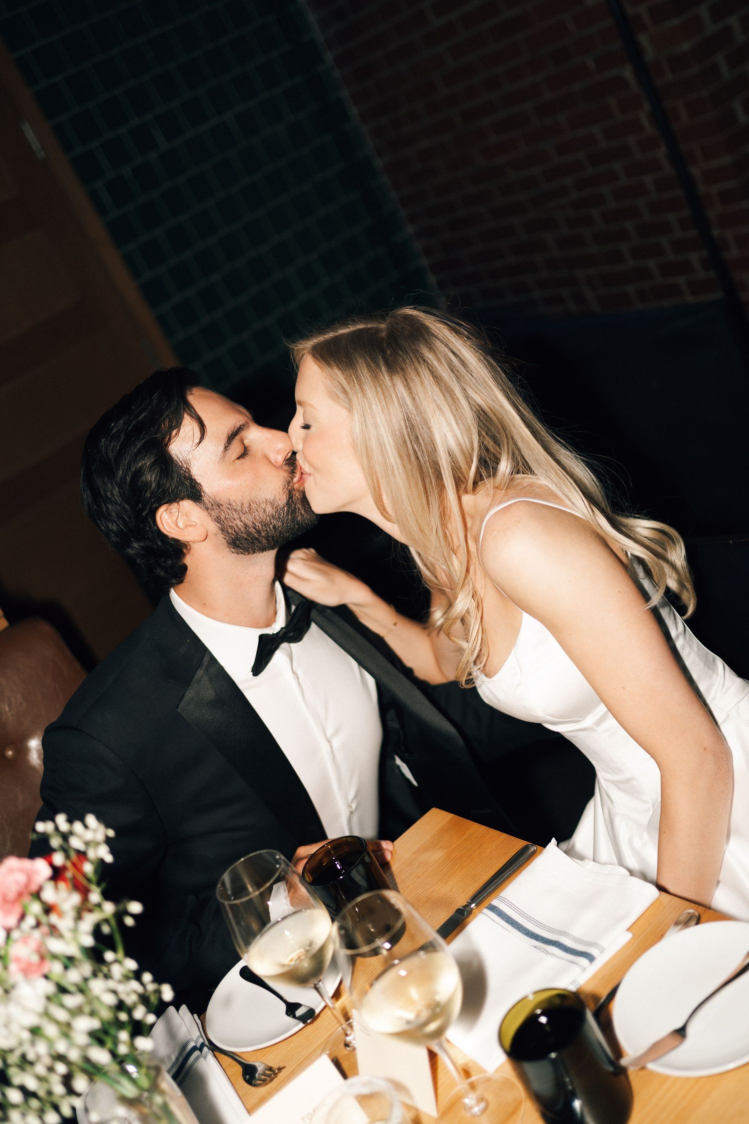 A candid wedding reception moment captured in sequence with decorative lighting and floral arrangements in Halifax, Nova Scotia.