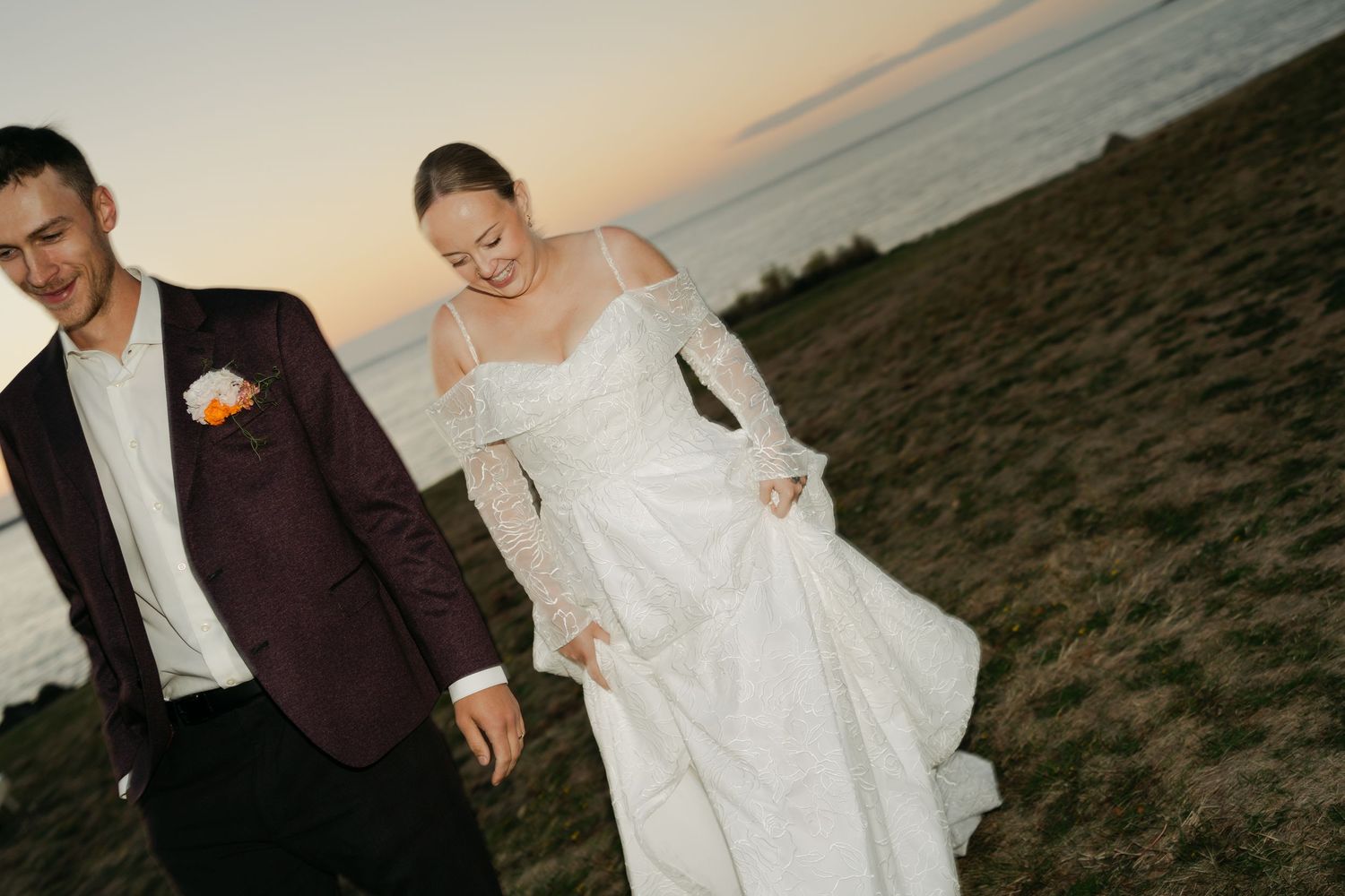 Newlyweds share a joyful moment together during golden hour against a scenic backdrop in Nova Scotia.