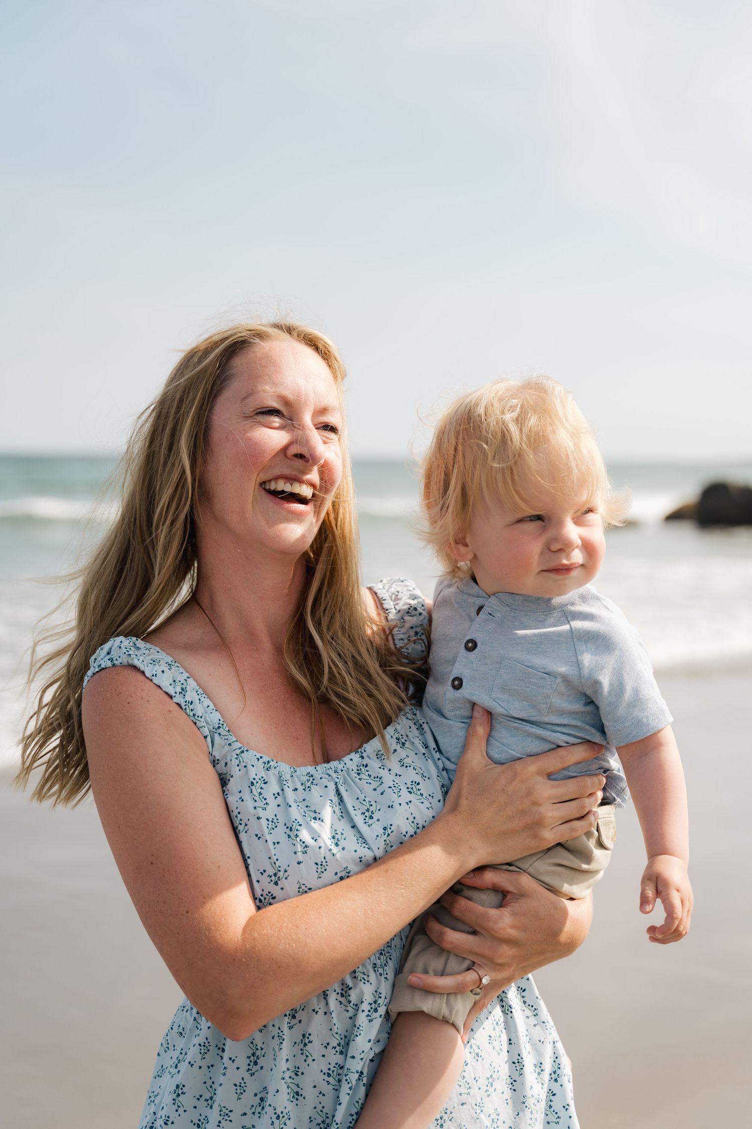 A joyful moment shared between parent and child playing together at a sunny beach in Halifax, Nova Scotia.