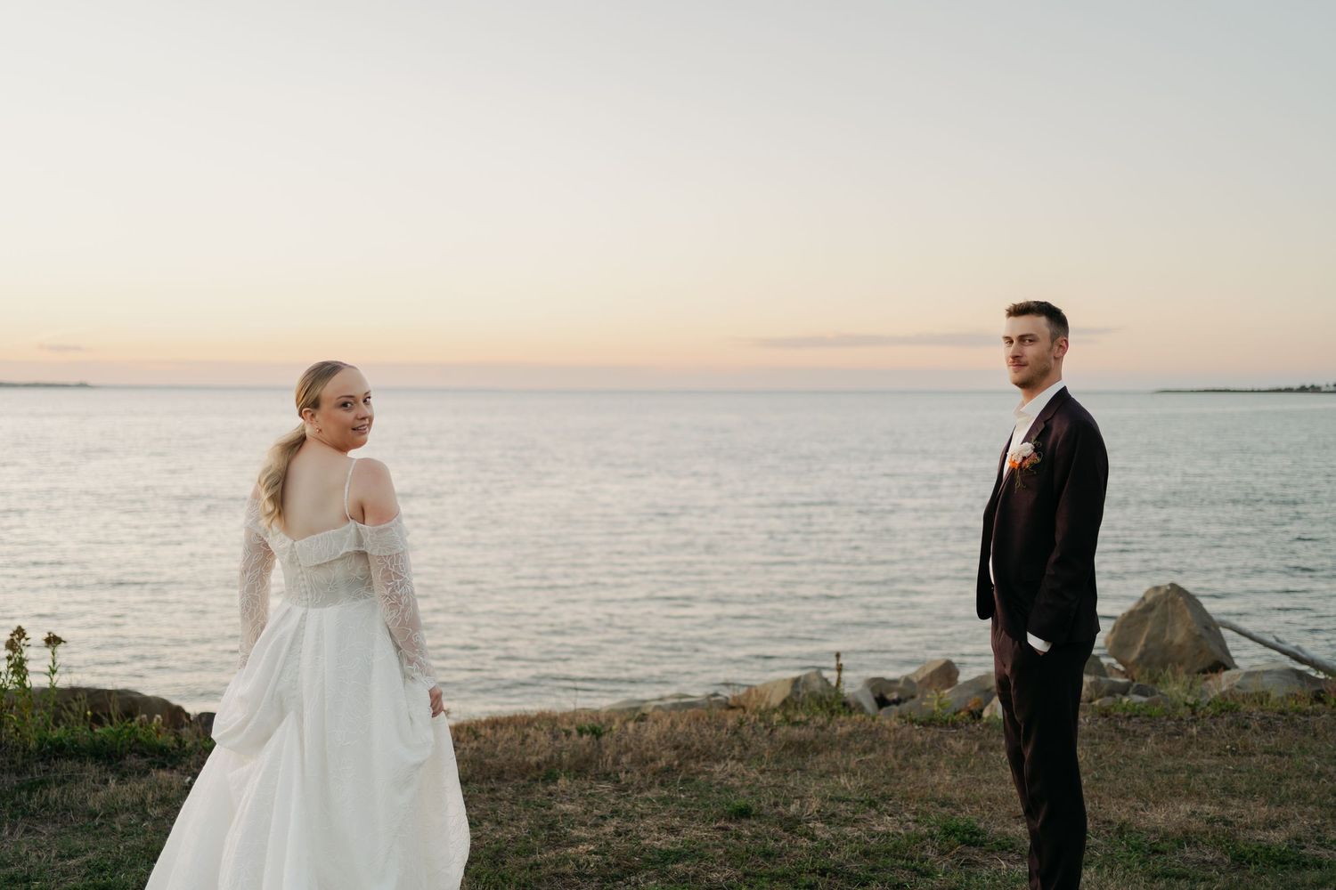 Romantic sunset wedding photoshoot by the ocean with soft golden light in Nova Scotia.