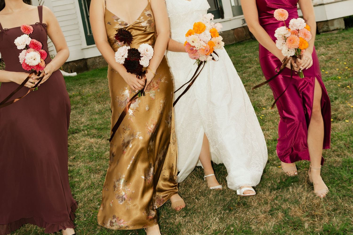 Wedding party showing off their shoes and dresses while standing on grass outdoors in Nova Scotia.
