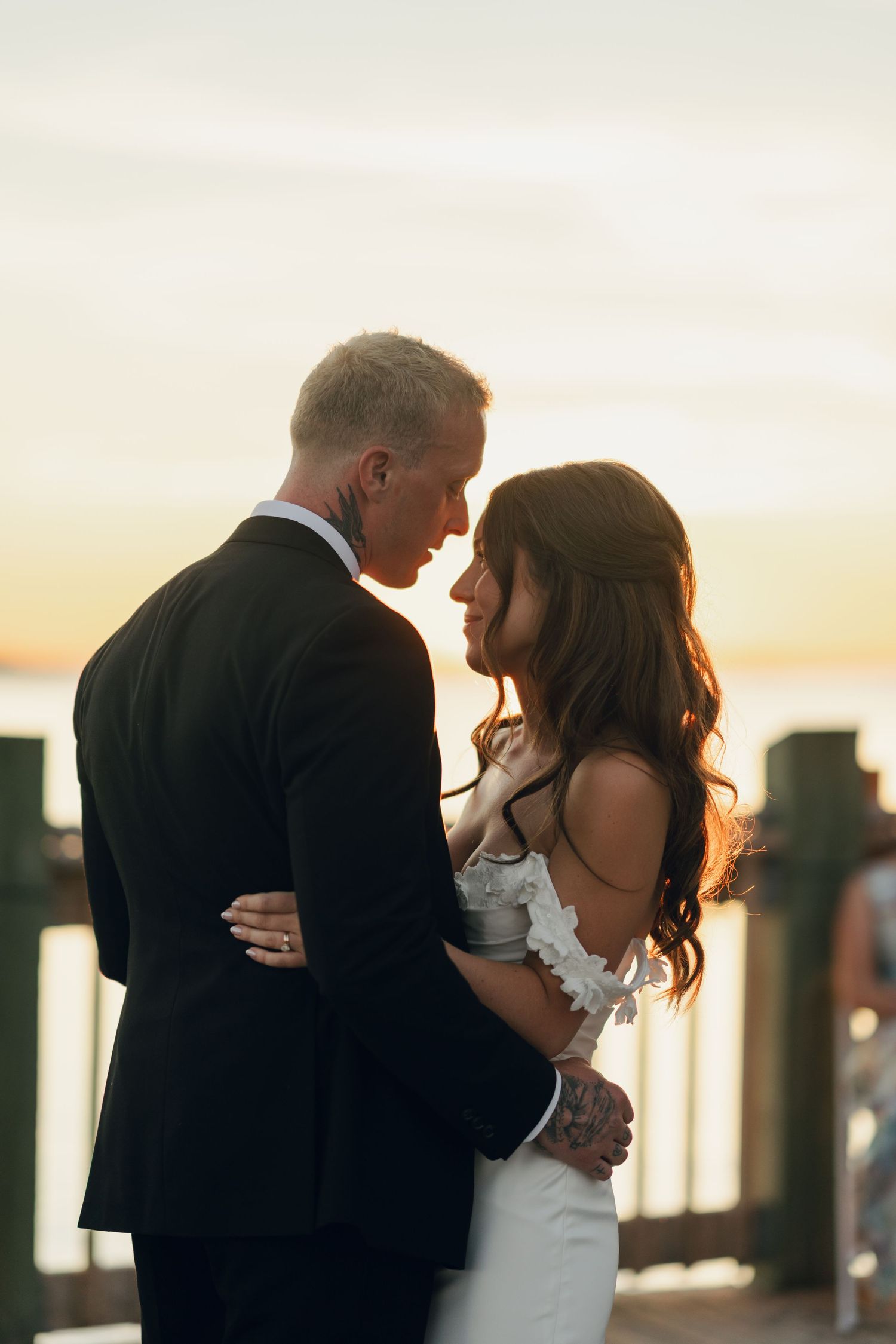 Romantic sunset dance sequence of newlyweds embracing on waterfront deck in Halifax, Nova Scotia.