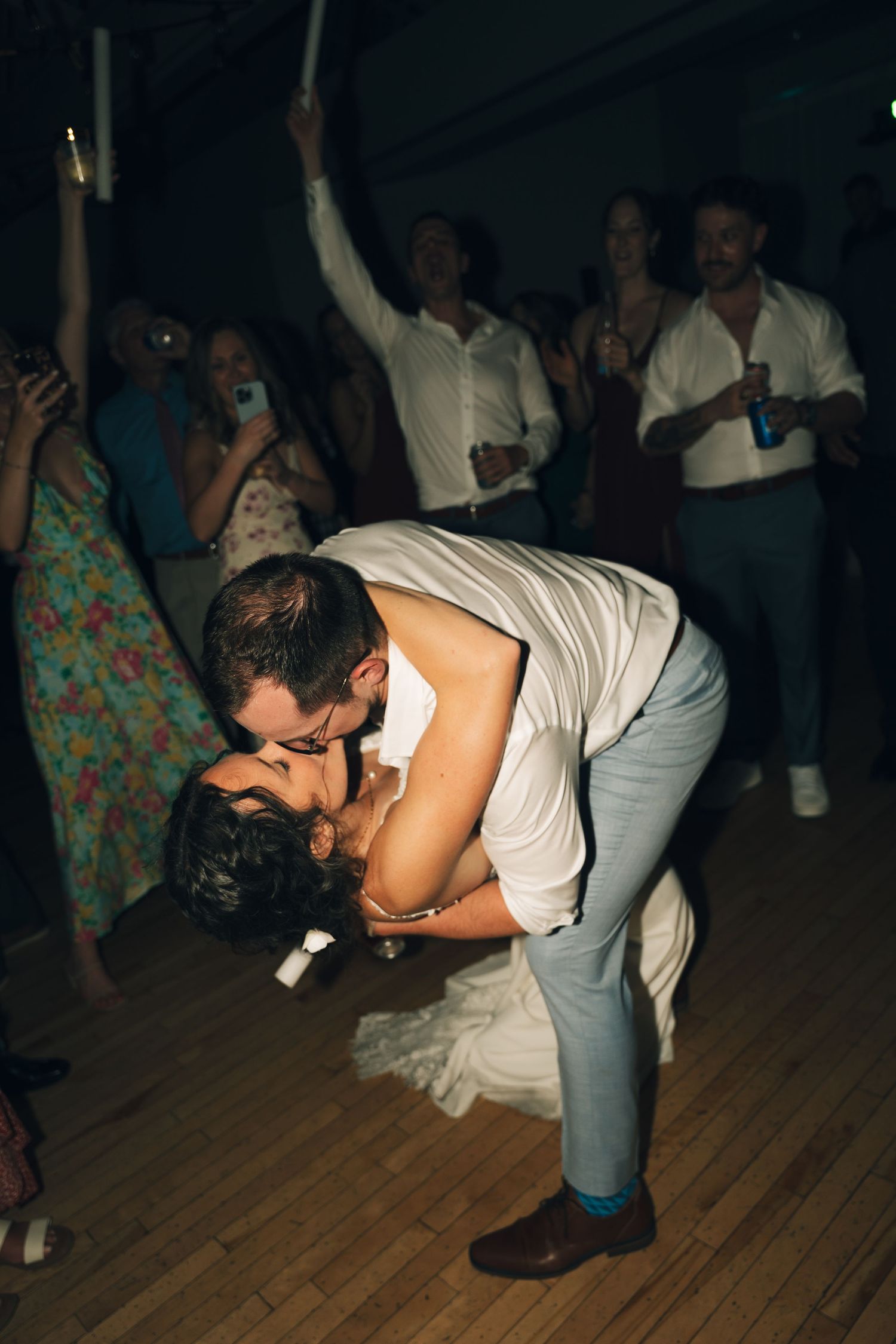 Wedding reception dance floor with couples dancing in dim lighting on wooden floor in Halifax, Nova Scotia.