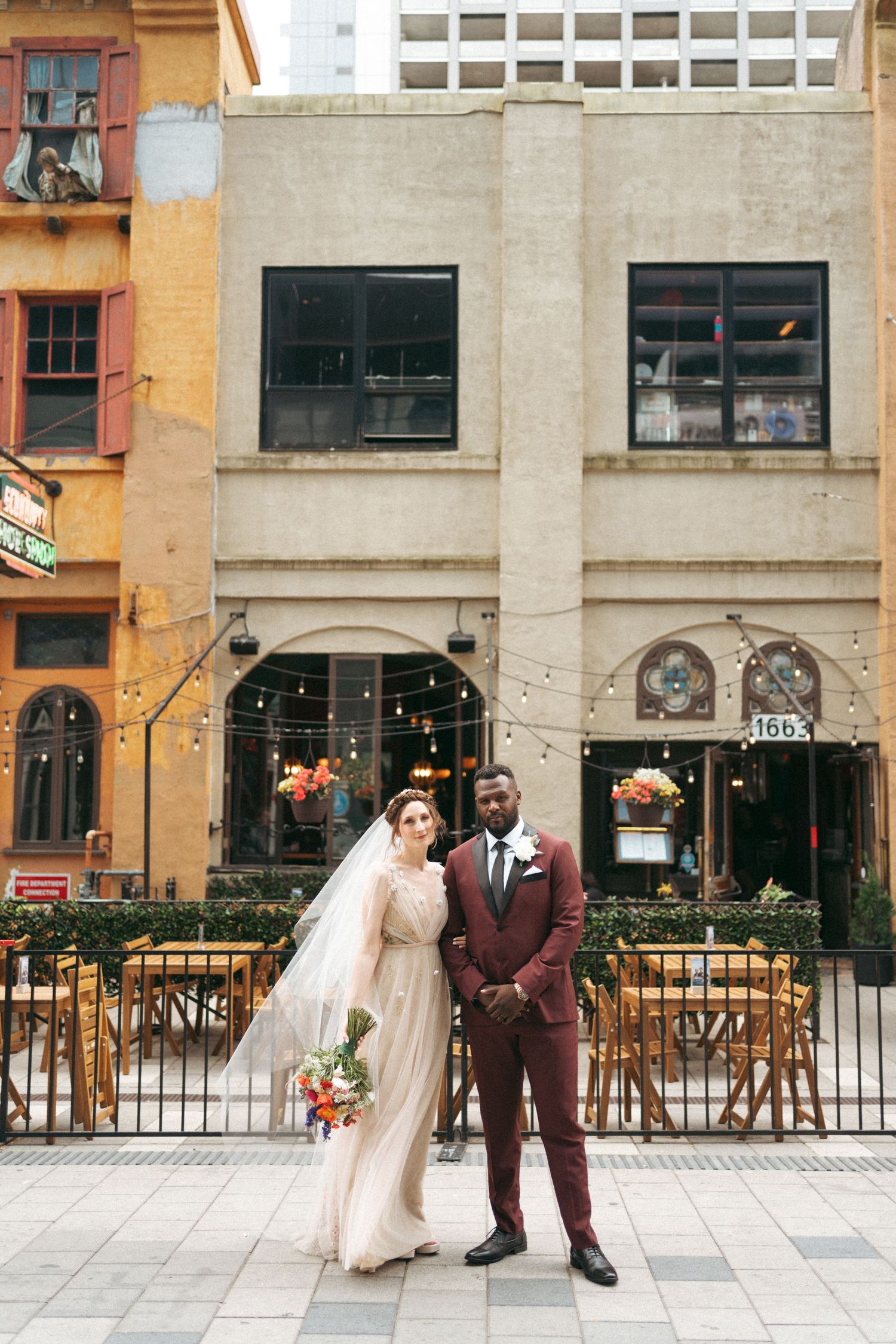 A series of wedding photos showing couples in formal attire posing on a city sidewalk with storefronts in the background in Halifax, NS.