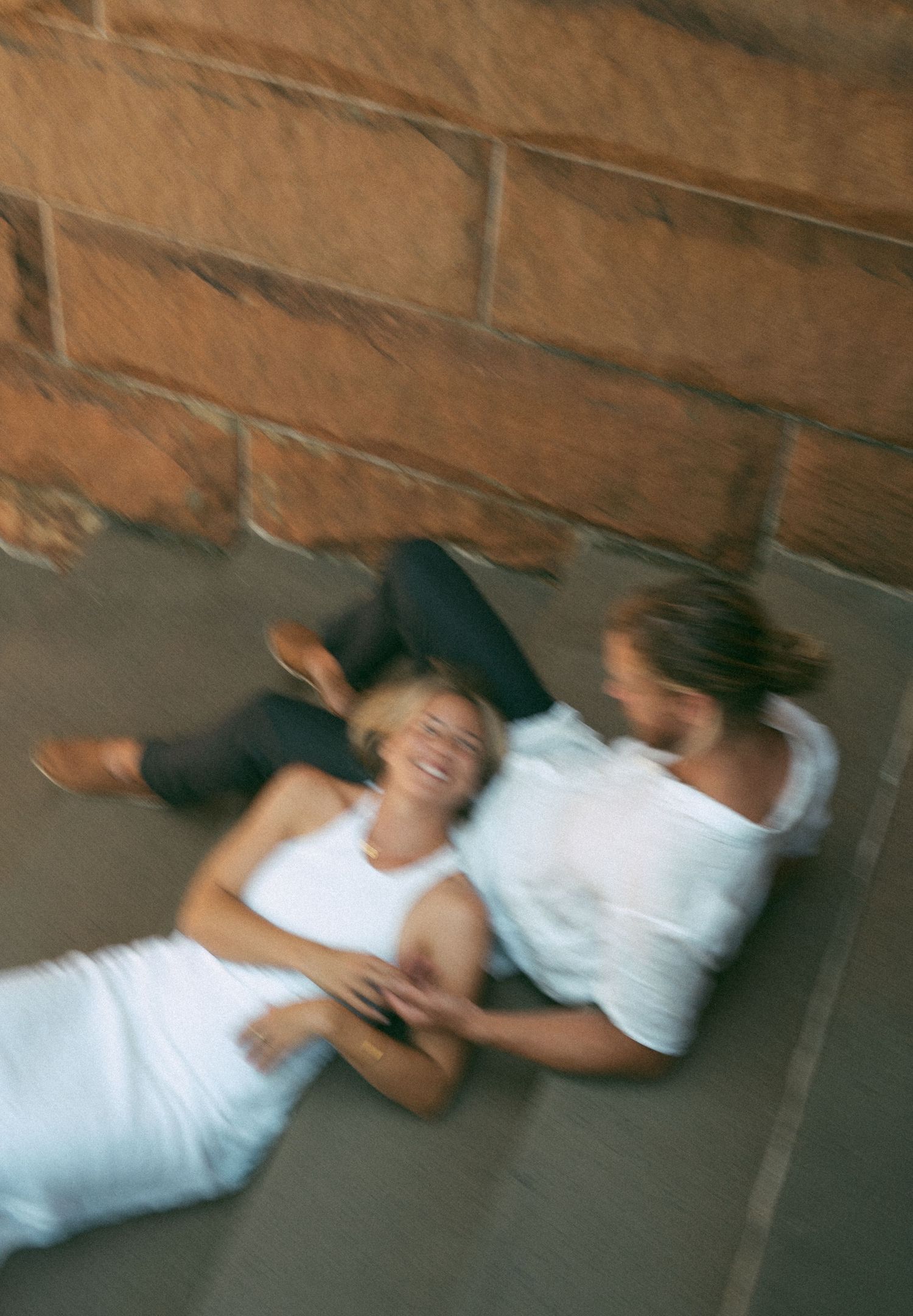 Motion-blurred sequence of a person in a white dress lying down on a concrete surface in Sydney, Australia.