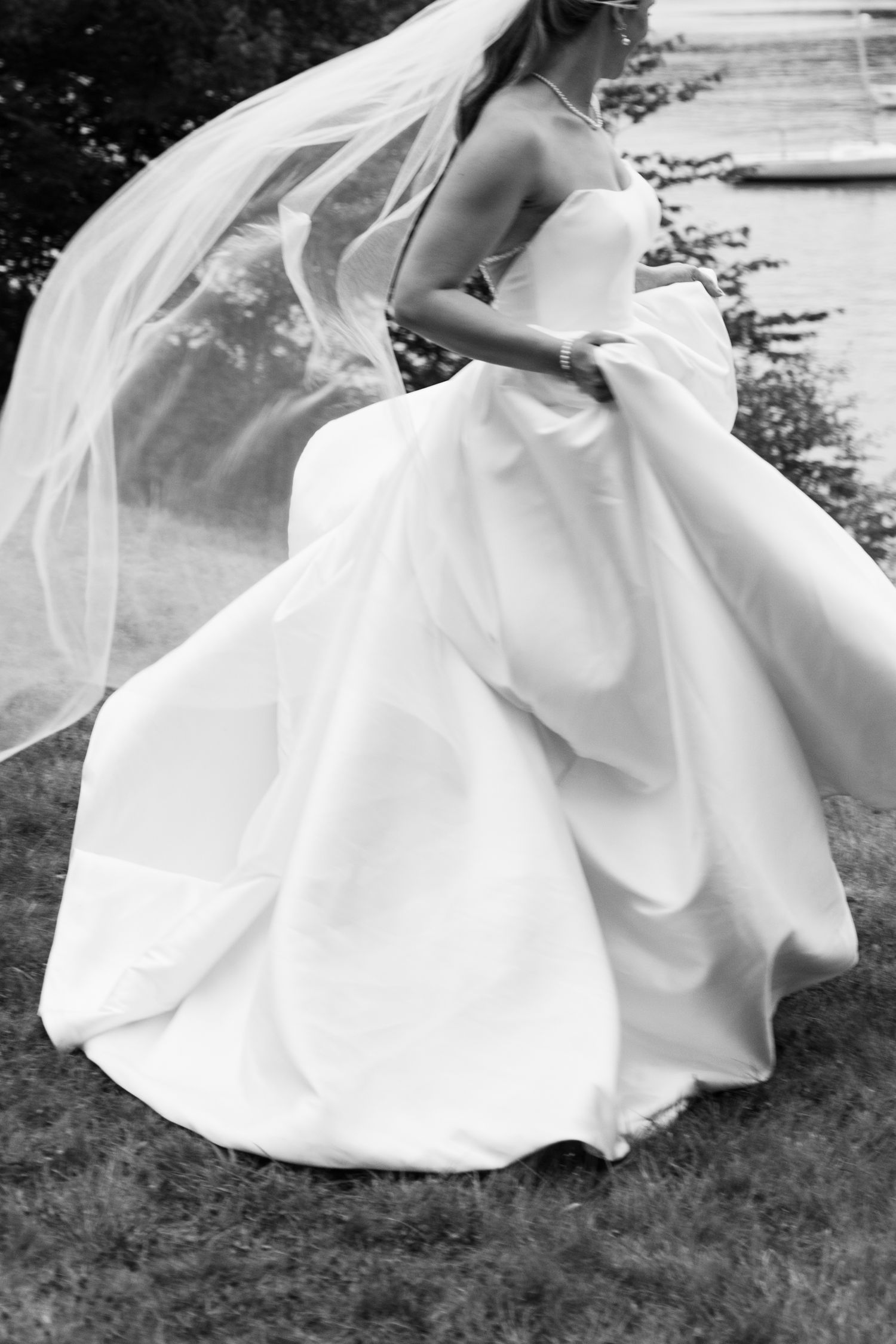 Black and white photos showing the flowing movement of a white wedding dress in a garden setting in Halifax, Nova Scotia.