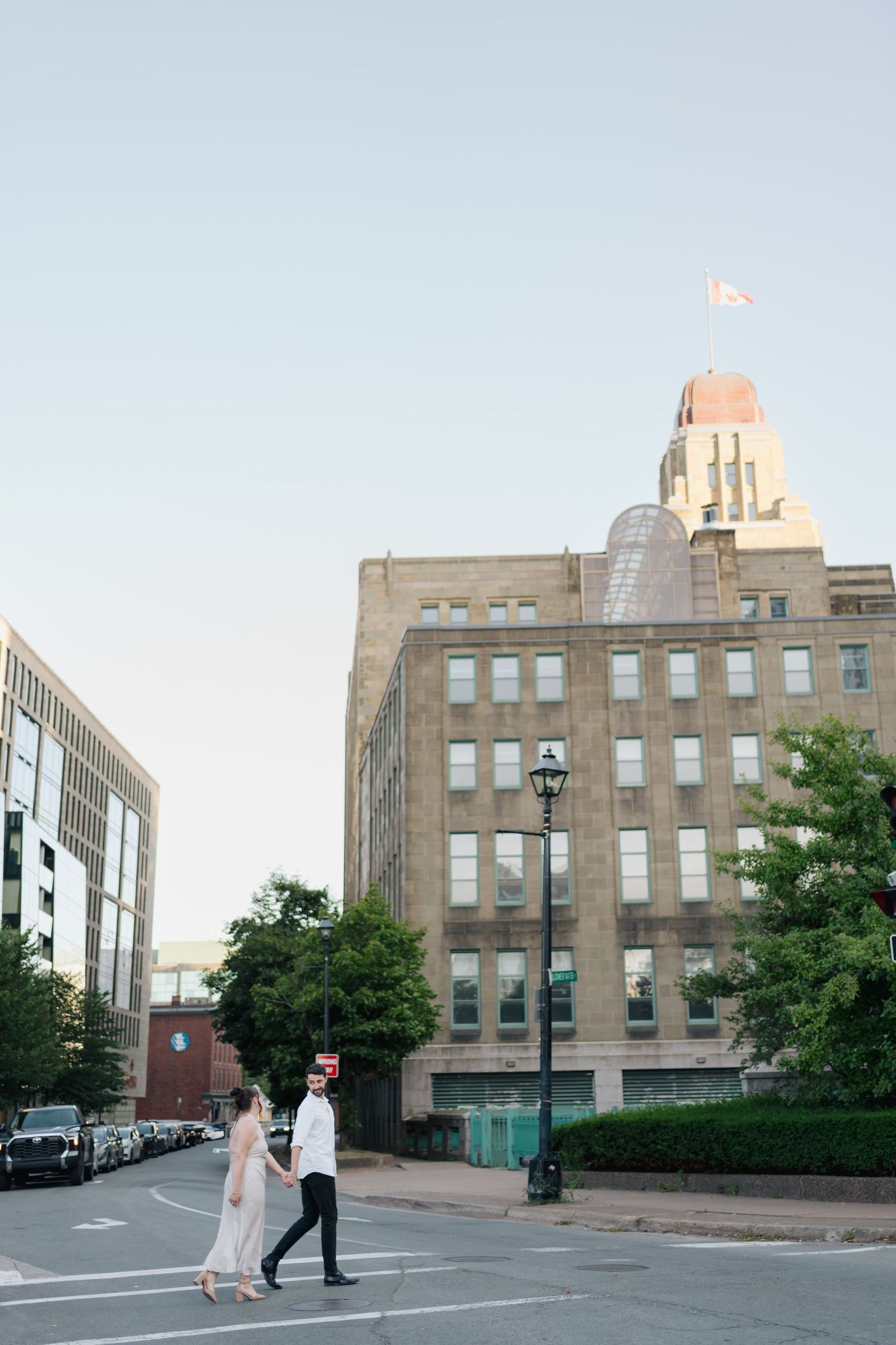 Art deco style building exterior with people walking near entrance and decorative architectural details in Halifax, Nova Scotia.