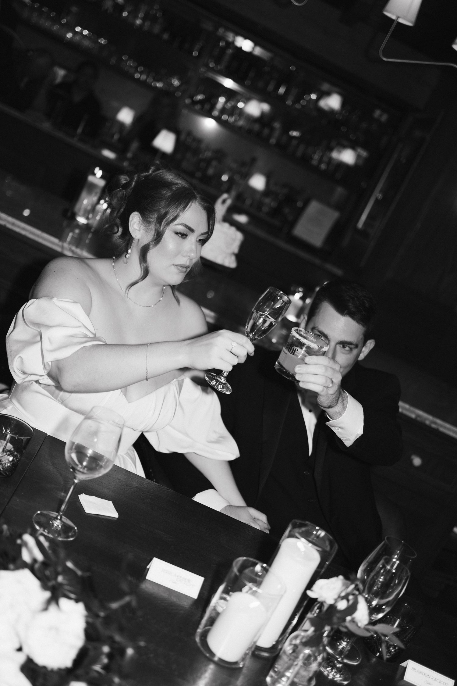 Artistic black and white photos of guests seated at a formal dining table with wine glasses at Lord Nelson Hotel, Halifax, Nova Scotia.