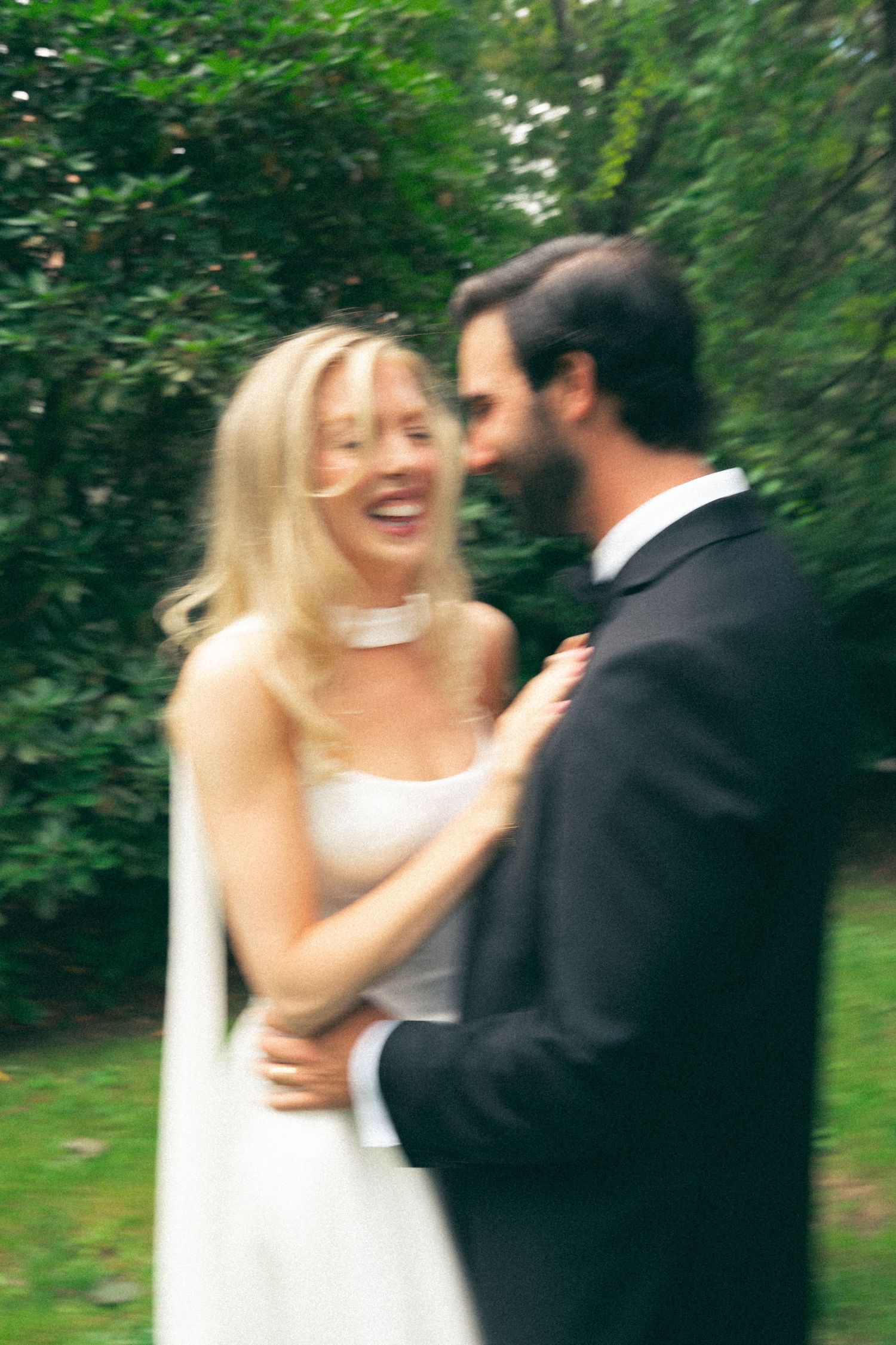Newlyweds sharing a playful dance moment in a garden setting in Halifax, Nova Scotia.