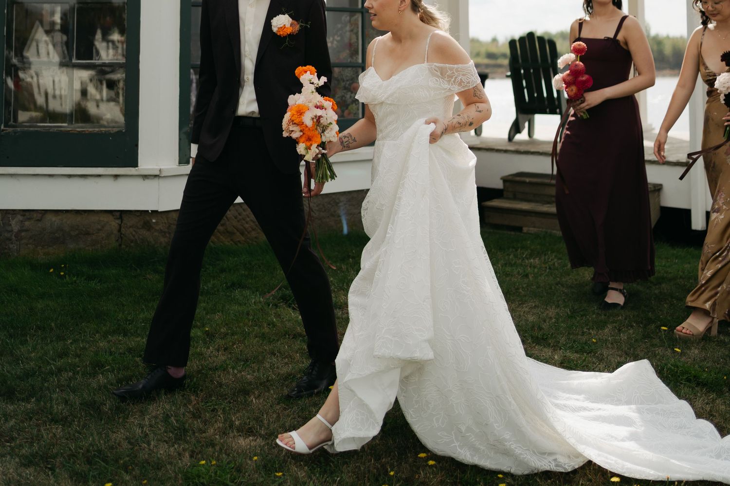 Couple dancing at an outdoor wedding reception with guests watching in the background in Nova Scotia.