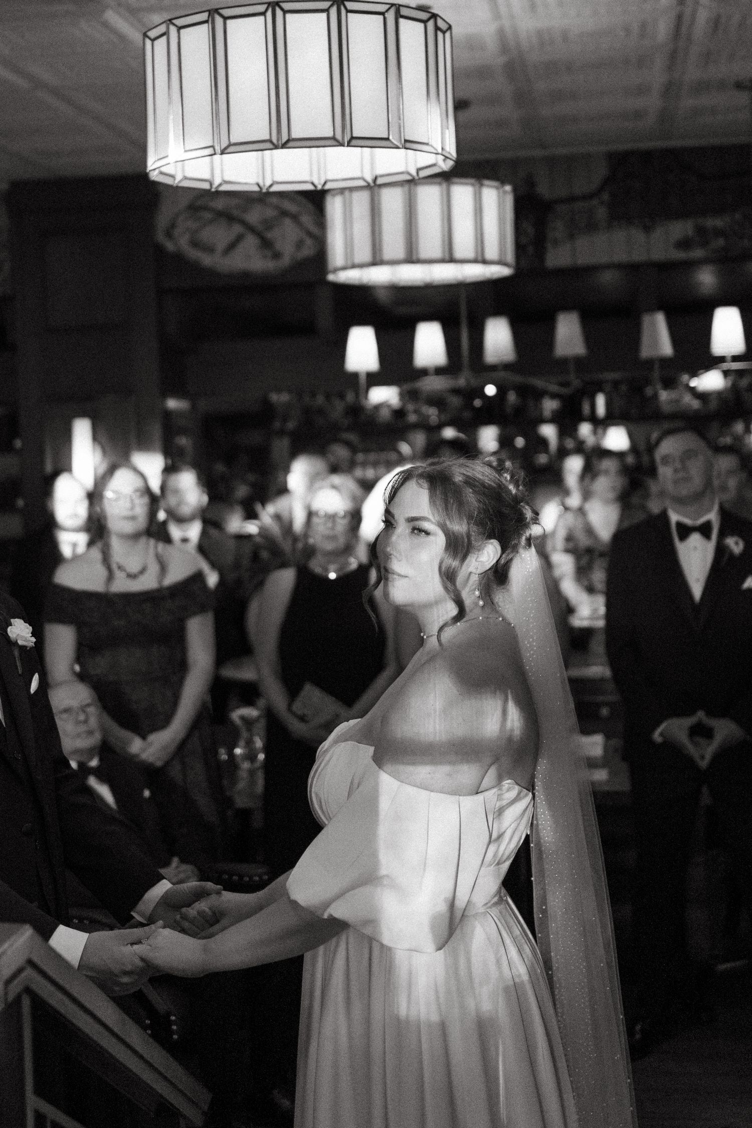 Black and white wedding reception photos showing guests dancing under elegant drum shade pendant lights at Lord Nelson Hotel, Halifax, NS.
