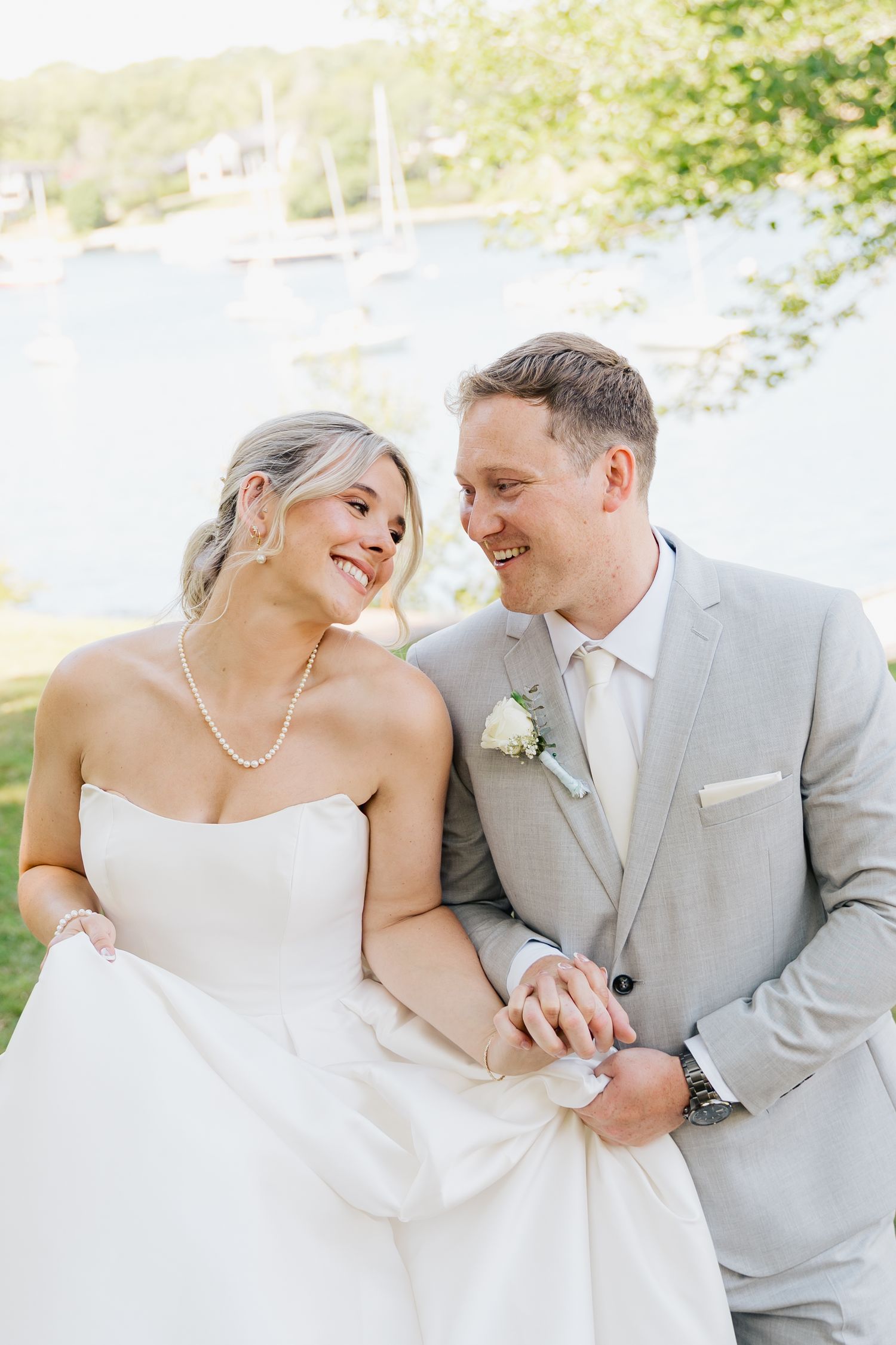 Romantic wedding couple in white and gray formal attire share intimate moments during their photoshoot in Halifax, Nova Scotia.