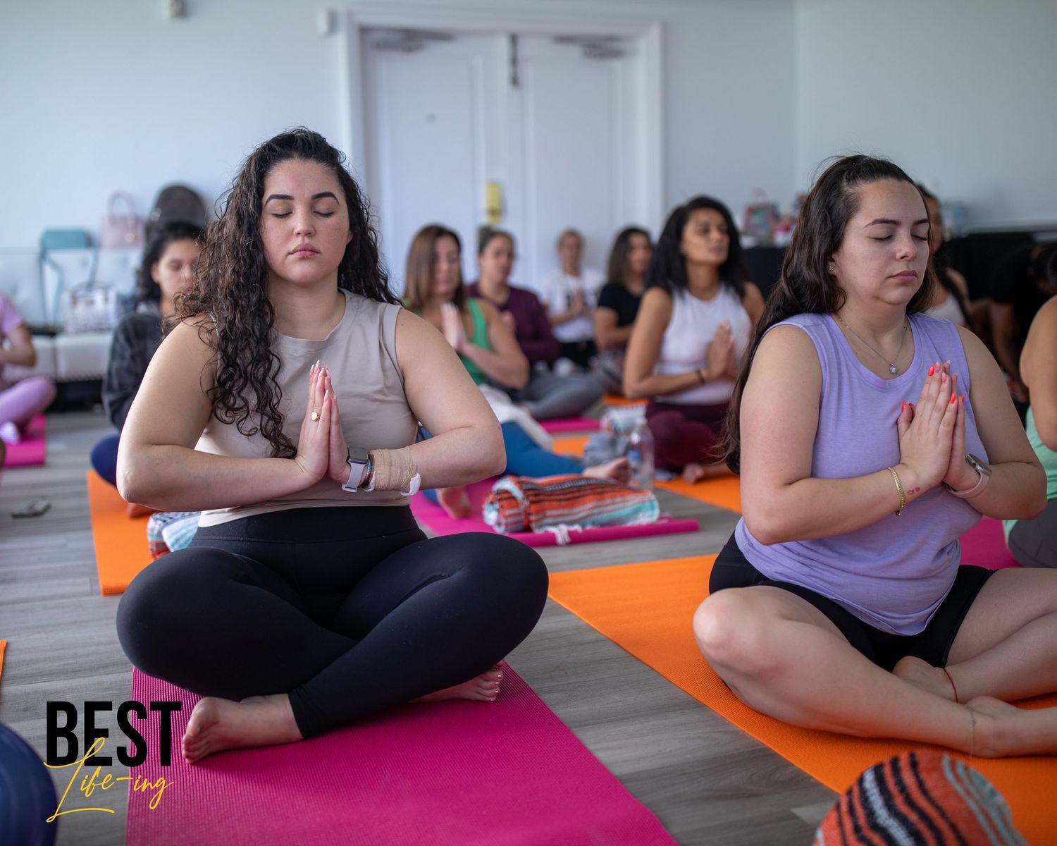 group of women doing yoga and meditation for corporate retreat